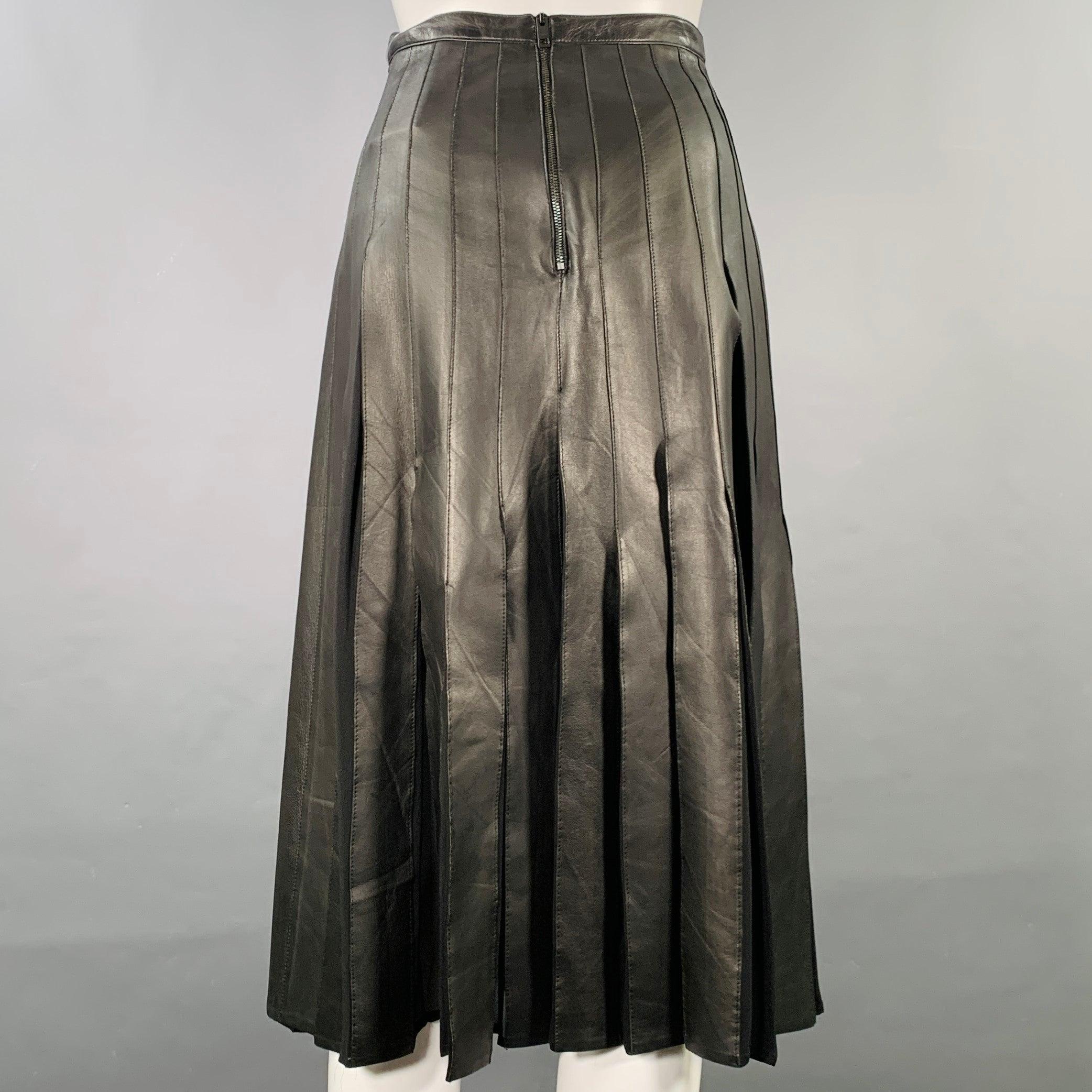 BURBERRY LONDON skirt comes in a black leather featuring a pleated style with silk panels, midi length, and a back zip up closure. Made in Italy.Very Good Pre-Owned Condition. Fabric tag removed. 

Marked:   Size tag removed. 

Measurements: 
 