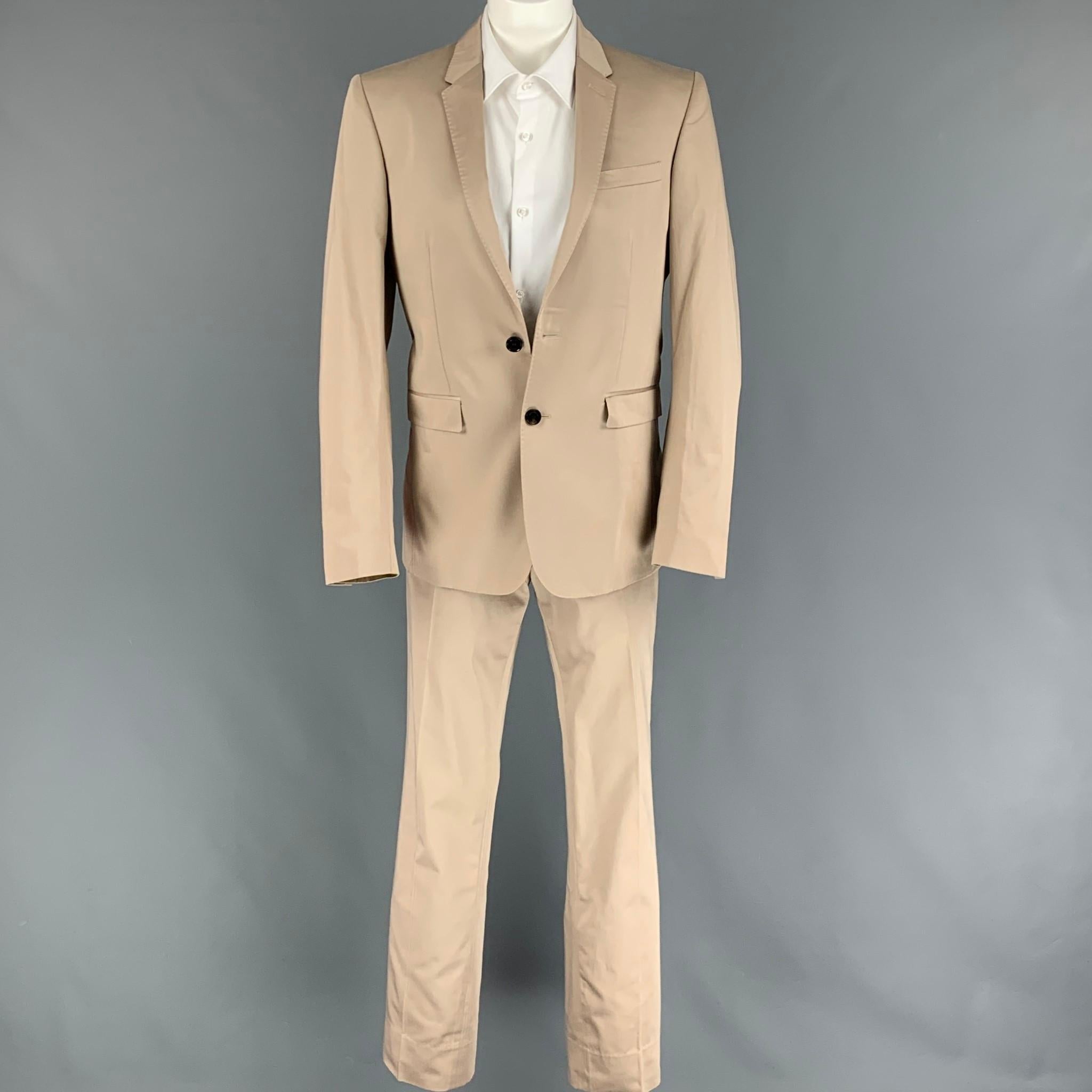 BURBERRY LONDON suit comes in a beige cotton with a full plaid liner and includes a single breasted, double button sport coat with a notch lapel and matching flat front trousers. Made in Portugal.

New With Tags.
Marked: 46R
Original Retail Price: