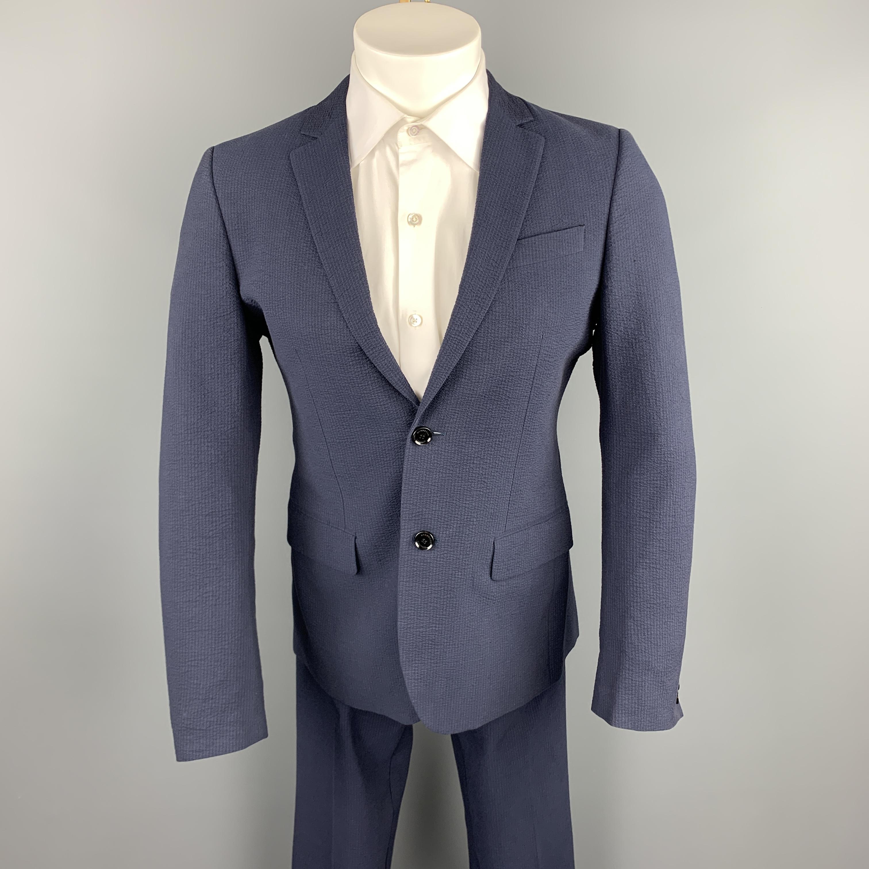 BURBERRY LONDON suit comes in a navy seersucker cotton and includes a single breasted, two button sport coat with a notch lapel, monogram liner, and matching flat front trousers. Made in Italy

New With Tags.
Marked: 46 S
Original Retail Price: