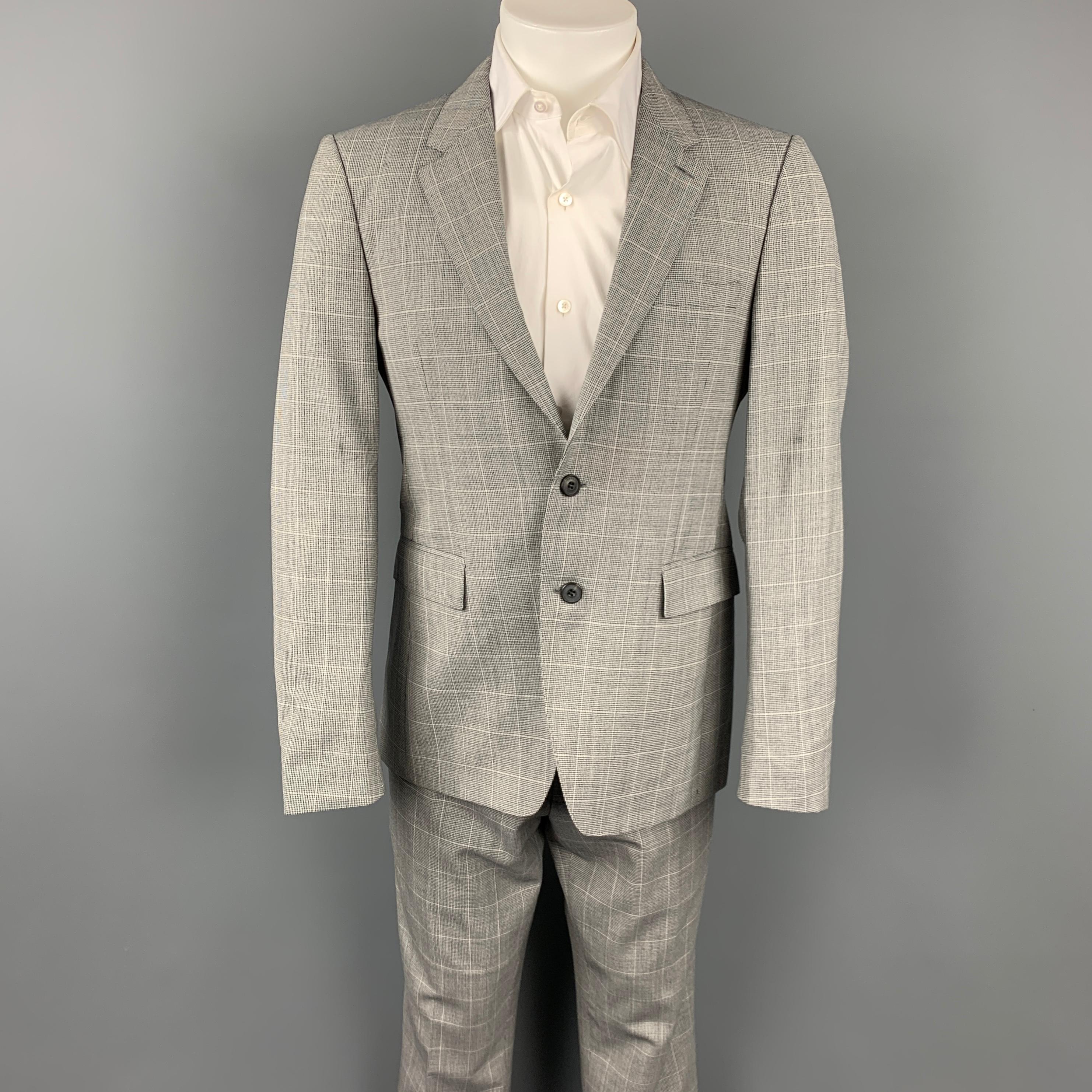 BURBERRY LONDON suit comes in a grey glenplaid virgin wool with a full liner and includes a single breasted,  two button sport coat with a notch lapel and matching flat front trousers. Made in Italy.

Very Good Pre-Owned Condition.
Marked: 48