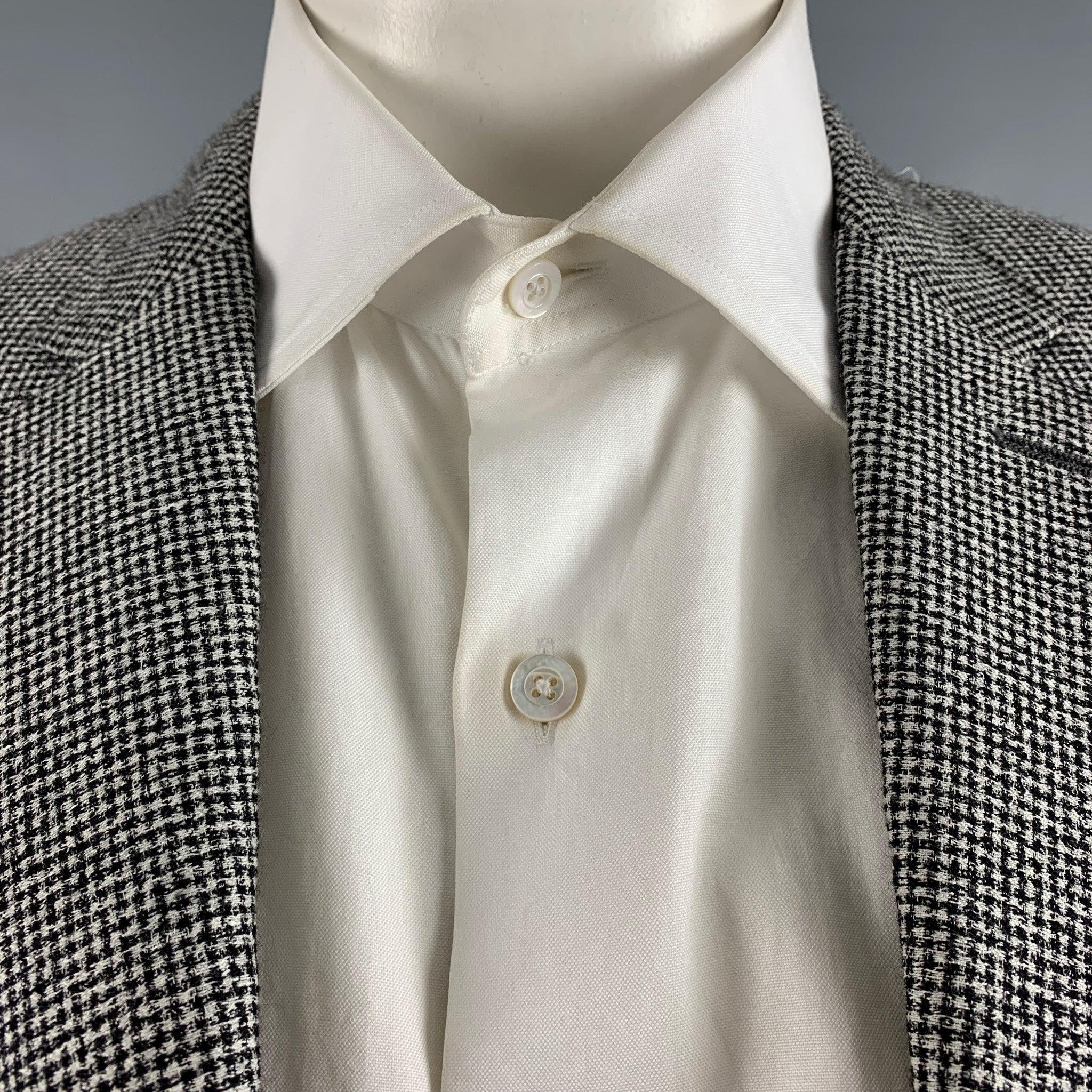 BURBERRY LONDON sport coat comes in a black and white houndstooth cotton blend woven with a no liner featuring a notch lapel, single back vent, and a double button closure. Made in Italy. Excellent Pre-Owned Condition. 

Marked:   52 R