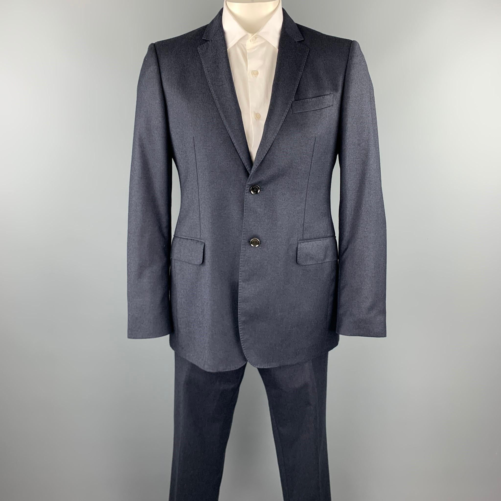 BURBERRY LONDON suit comes in a navy wool with a full monogram print liner and includes a single breasted, two button sport coat with a notch lapel and matching flat front trousers. Made in Italy.

Excellent Pre-Owned Condition.
Marked: 52