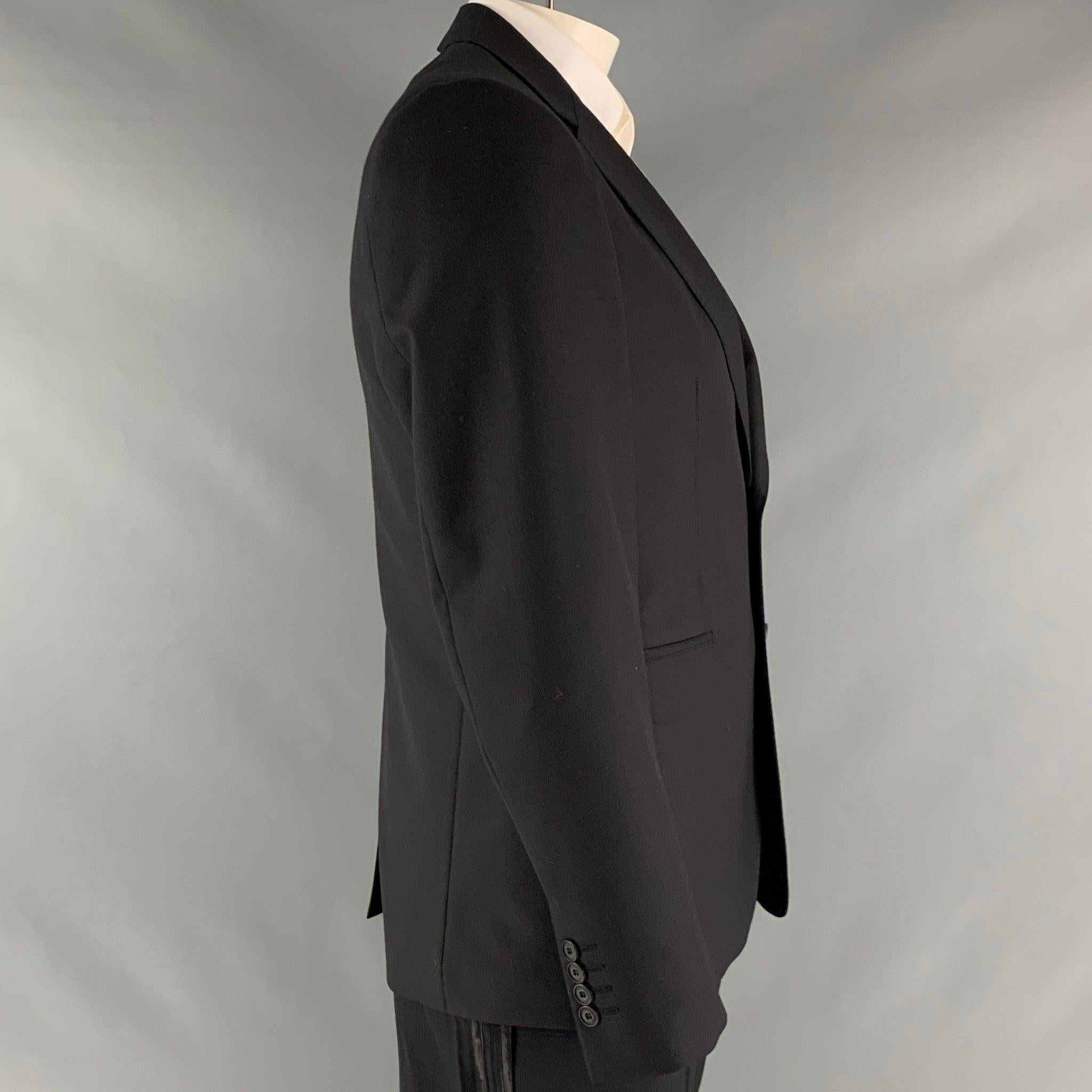 BURBERRY LONDON sport coat comes in a black wool material with a full liner featuring a notch lapel, single back vent, and a double button closure. Made in Italy. New with Tags. 

Marked:   52 

Measurements: 
 
Shoulder: 17.5 inches Chest: 42