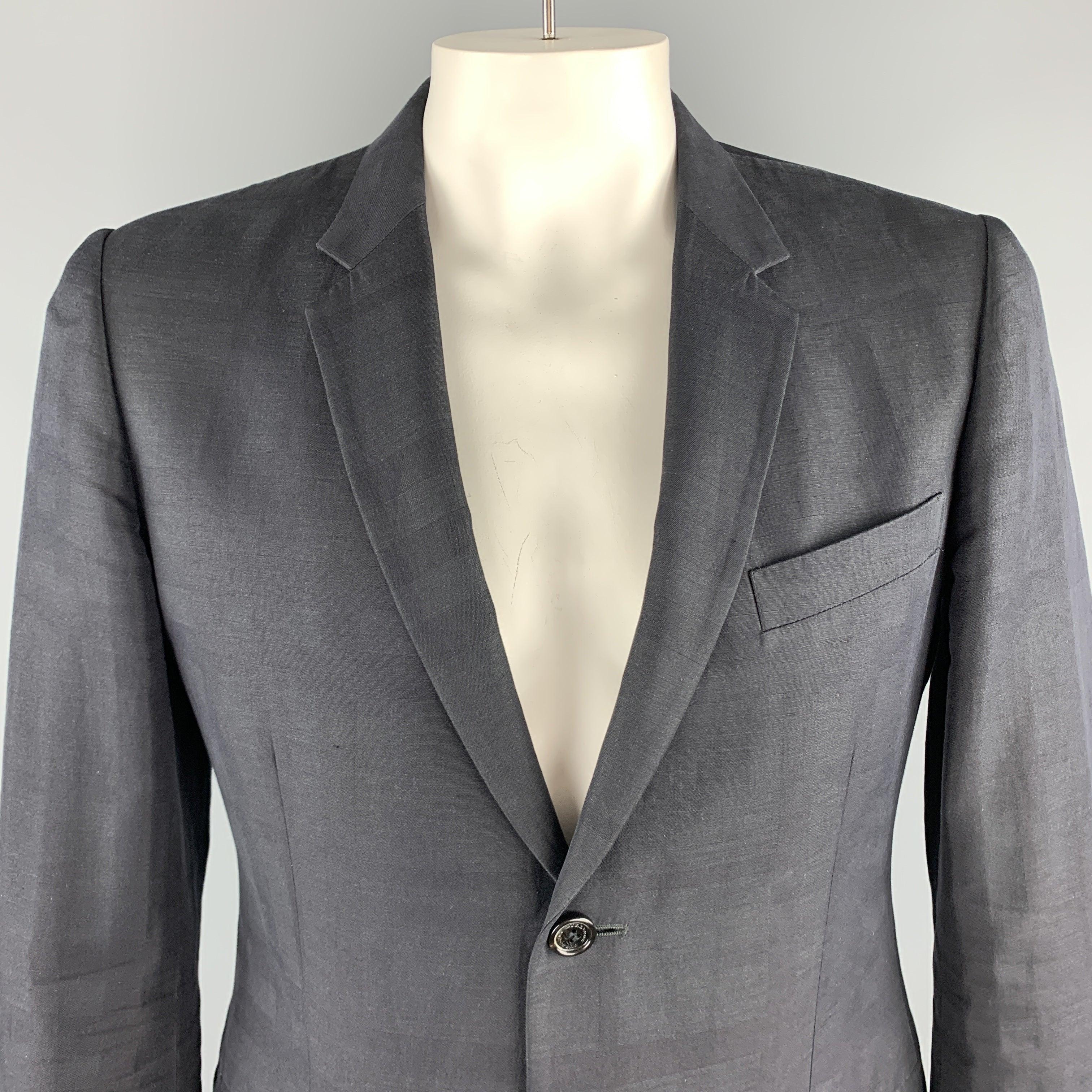 BURBERRY LONDON
sport coat comes in black on black plaid cotton, linen, and
 wool blend woven material with a notch lapel, single breasted, two button front, and double vented back. Made in Portugal.Very Good Pre-Owned Condition.
 

Marked:   IT 5