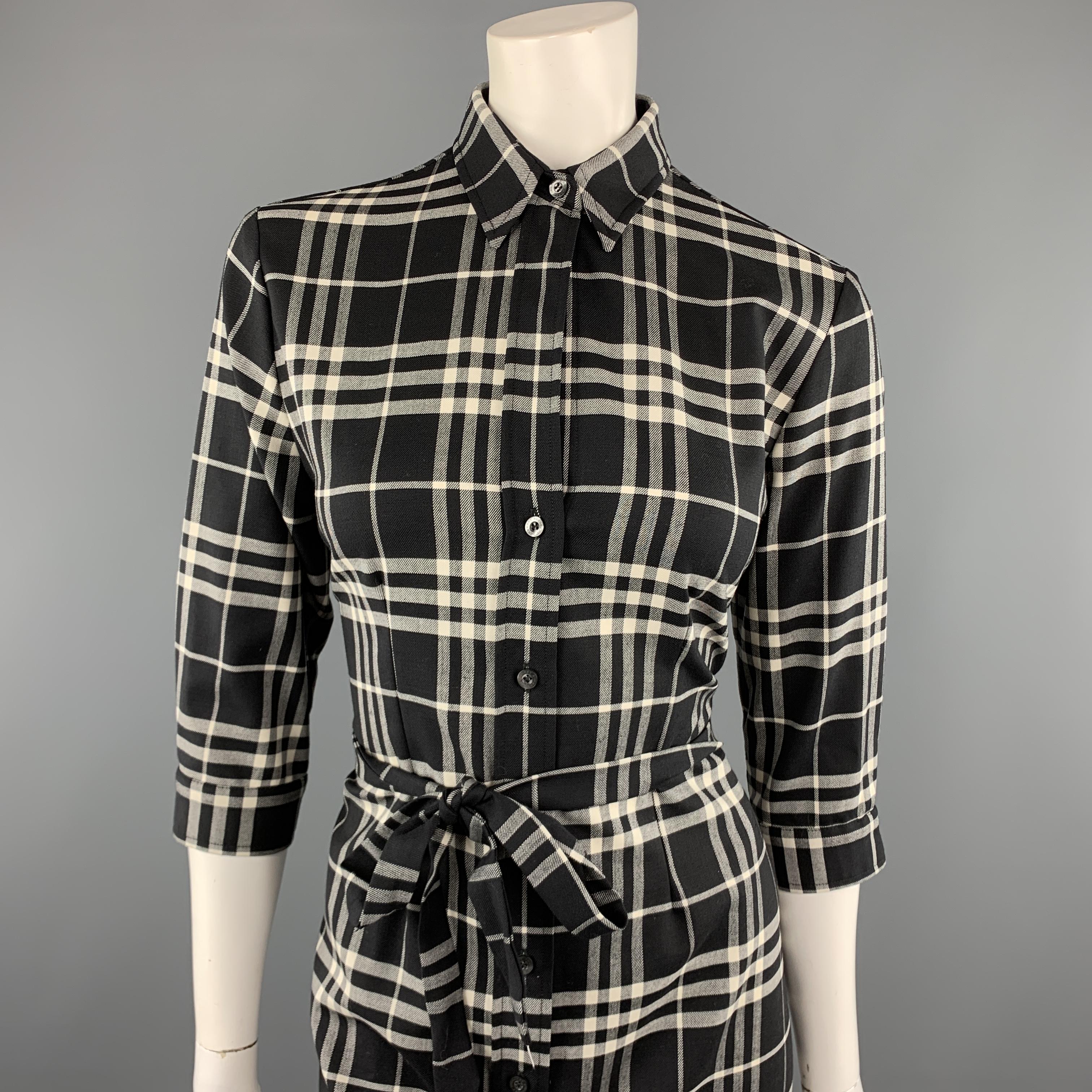 BURBERRY LONDON shirt dress comes in black and white plaid stretch wool twill with a pointed collar, three quarter sleeve, A line skirt and tied belt. Made in Italy.

Excellent Pre-Owned Condition.
Marked: 6

Measurements:

Shoulder: 15 in.
Bust: 38