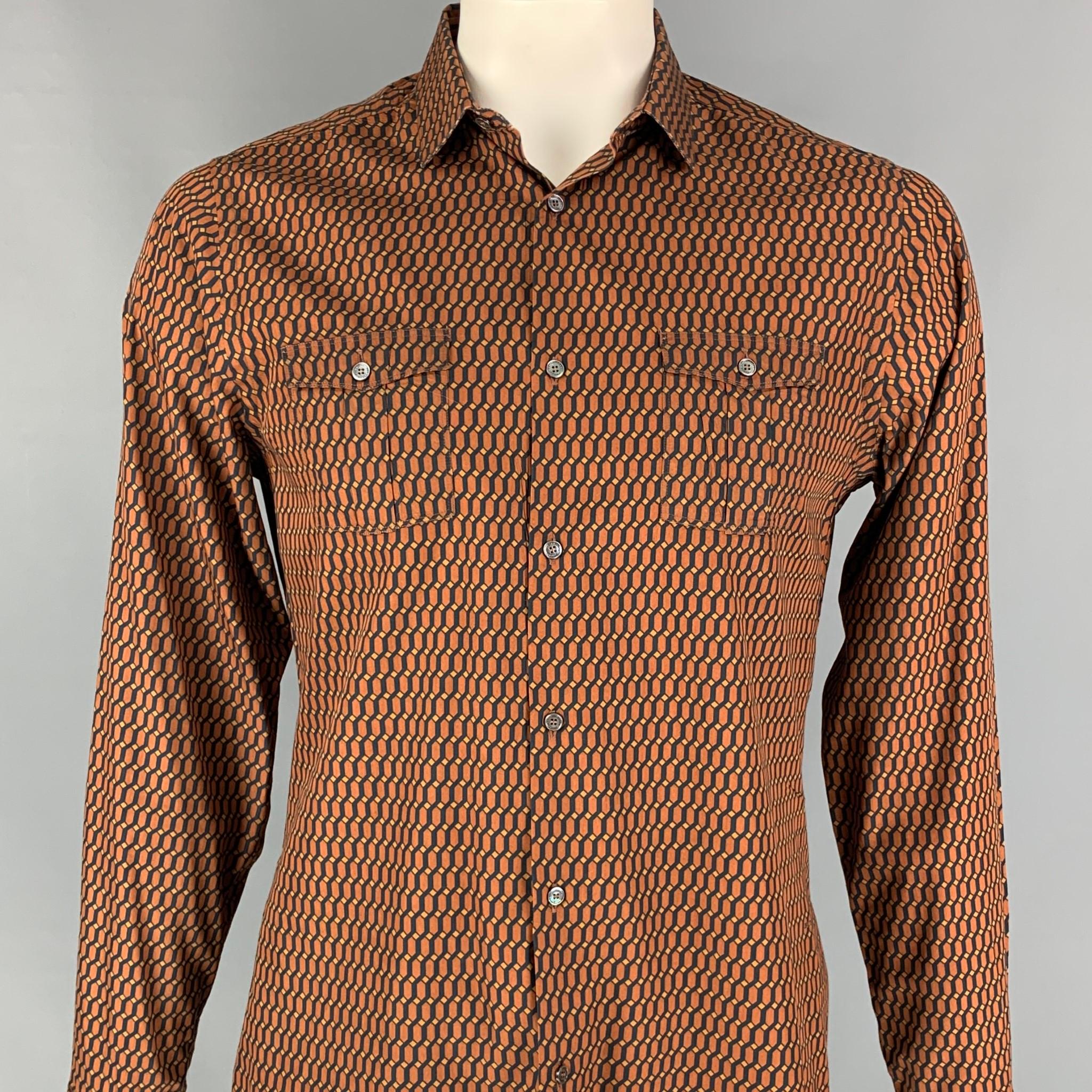BURBERRY LONDON long sleeve shirt comes in a rust & black geometric cotton / silk featuring a tailored fit, spread collar, front pockets, and a buttoned closure. 

Excellent Pre-Owned Condition.
Marked: L

Measurements:

Shoulder: 17.5 in.
Chest: 42