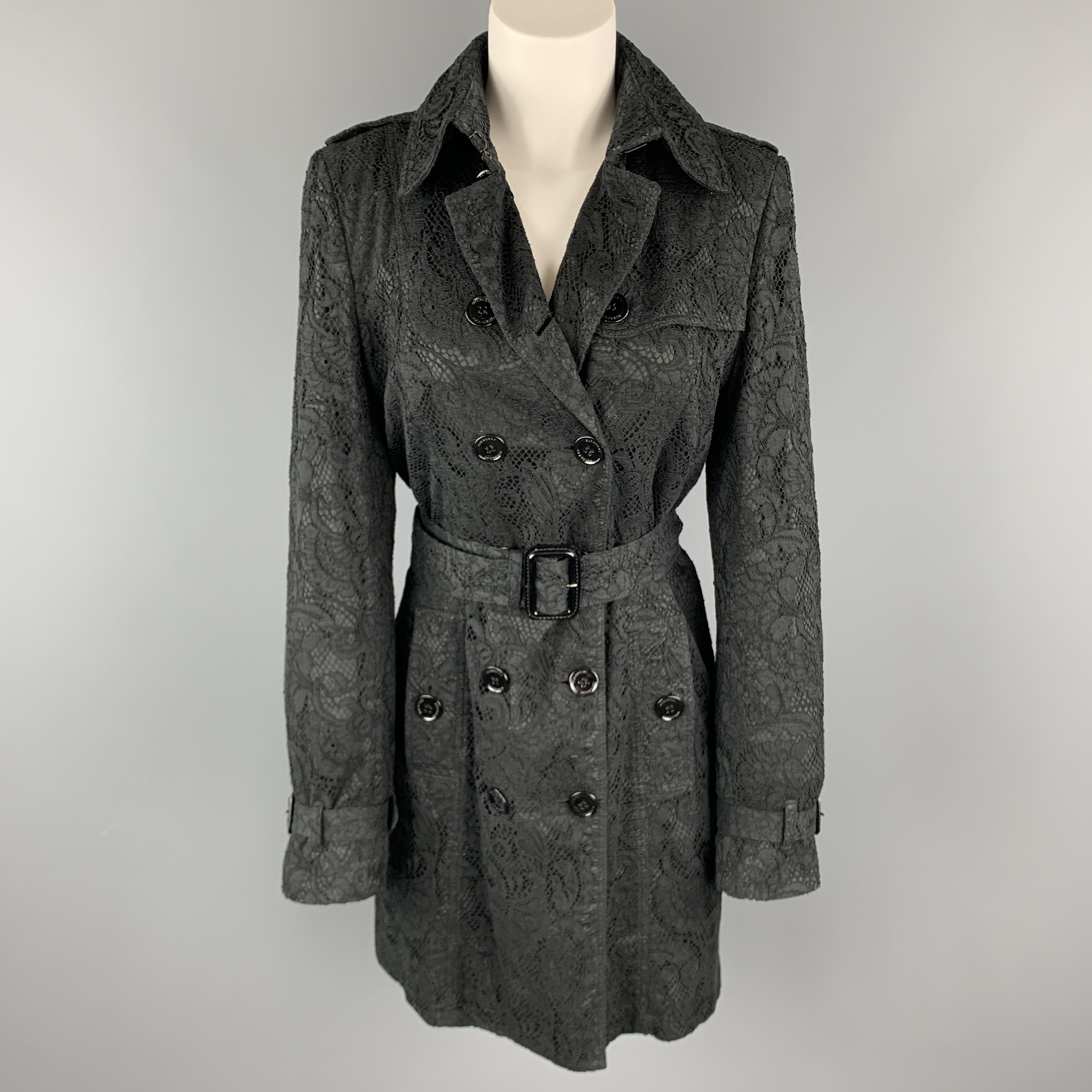 BURBERRY LONDON trench coat comes in a black lace overlay fabric with a double breasted button front, storm flap, epaulets, and belted waist and cuffs. Made in Poland.

Excellent Pre-Owned Condition.
Marked: M

Measurements:

Shoulder: 16 in.
Bust: