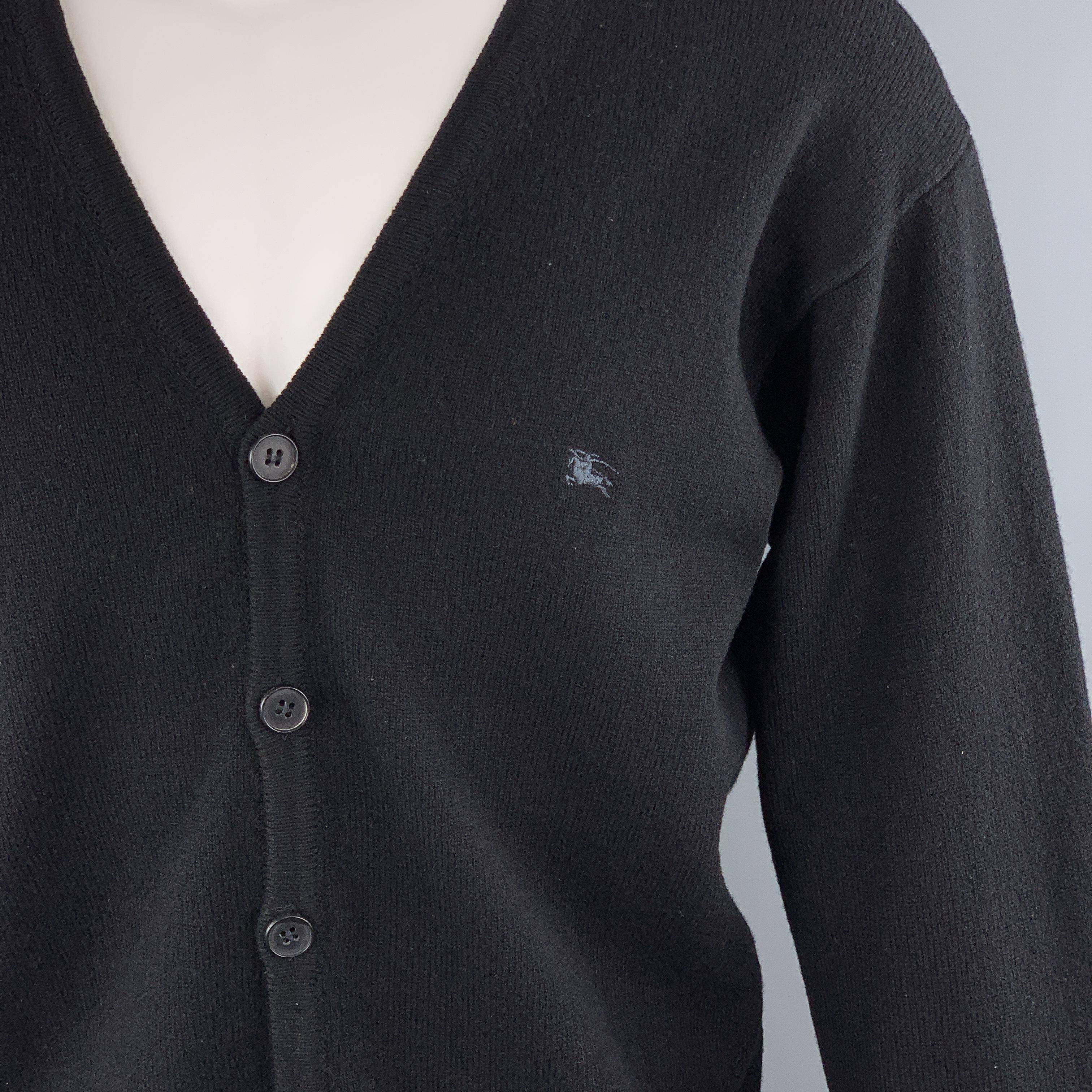 BURBERRY LONDON cardigan comes in black wool knit with a V neck, button up front, and chest embroidery. Made in Italy.

Excellent Pre-Owned Condition.
Marked: M

Measurements:

Shoulder: 22 in.
Chest: 48 in.
Sleeve: 26 in.
Length: 27.5 in.