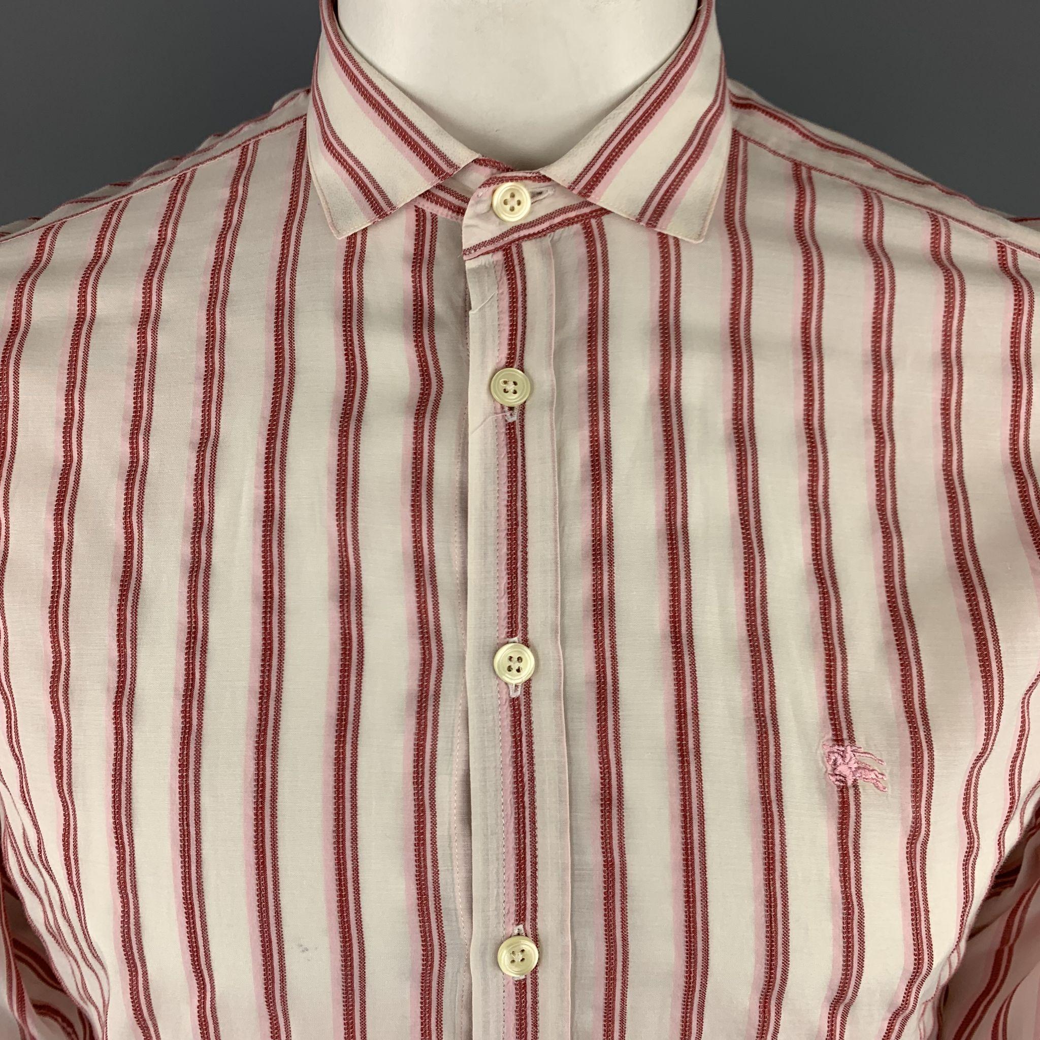 BURBERRY LONDON Long Sleeve Shirt comes in a brick tone in a striped cotton blend material, with a spread collar, double buttoned cuffs, button up. Made in the UK.
 
Very Good Pre-Owned Condition.
Marked: L
 
Measurements:
Shoulder: 17 in.
Chest: 46