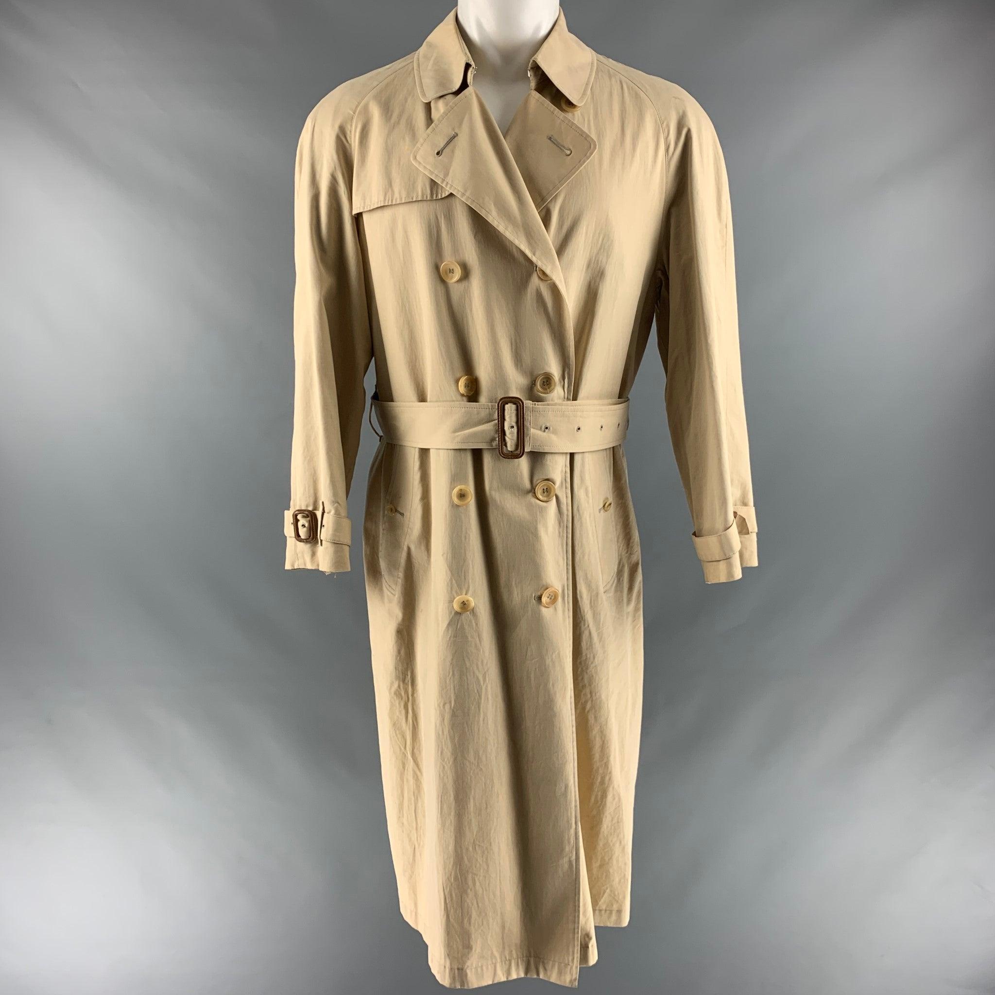 BURBERRY LONDON trench coat comes in khaki cotton and polyester gabardine woven material featuring a regular fit, double-breasted button closure​, hook-and-eye collar closure​, Epaulettes​, belt​, side button welt pockets​, belted cuffs​ back button