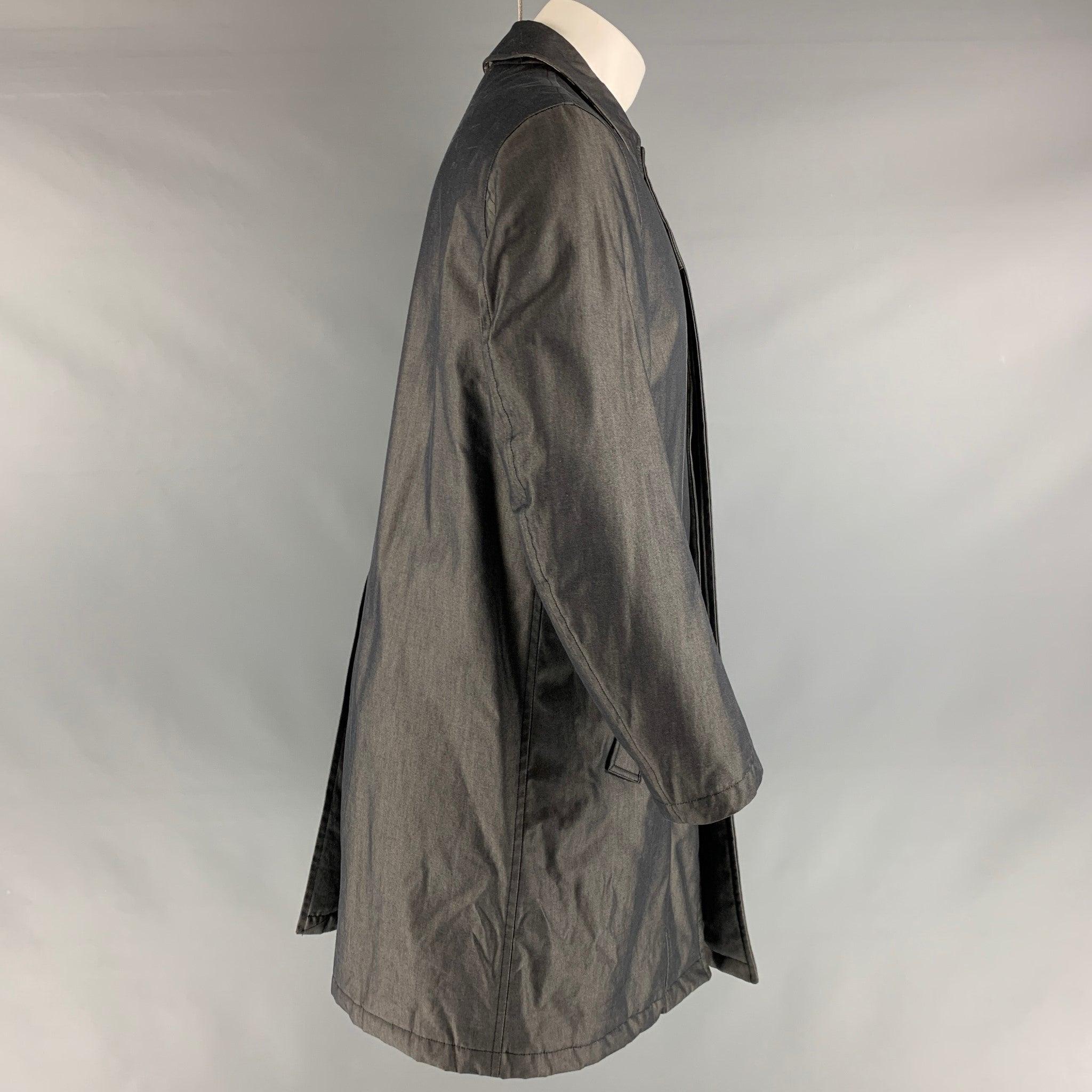 BURBERRY LONDON coat comes in grey cotton twill with a full lining featuring a pointed collar, slit pockets, single back vent, and hidden placket button closure. Made in Italy.Very Good Condition. Light wear. 

Marked: 
 S 

Measurements: 
 Chest: