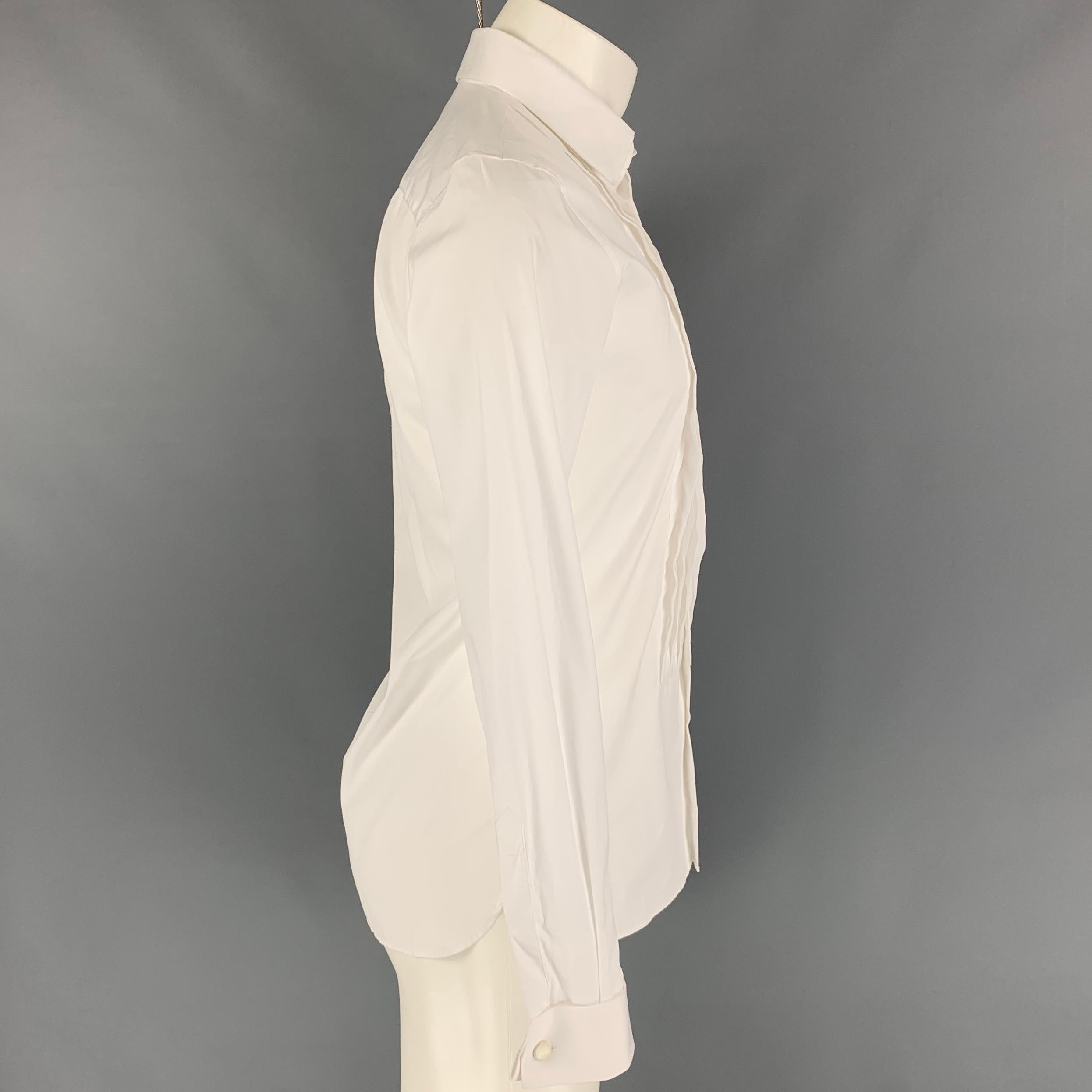 BURBERRY LONDON tuxedo long sleeve shirt comes in a white cotton featuring a slim fit, pleated front, french cuffs, spread collar, and a hidden button closure. 

Very Good Pre-Owned Condition.
Marked: 15/38

Measurements:

Shoulder: 17.5 in.
Chest: