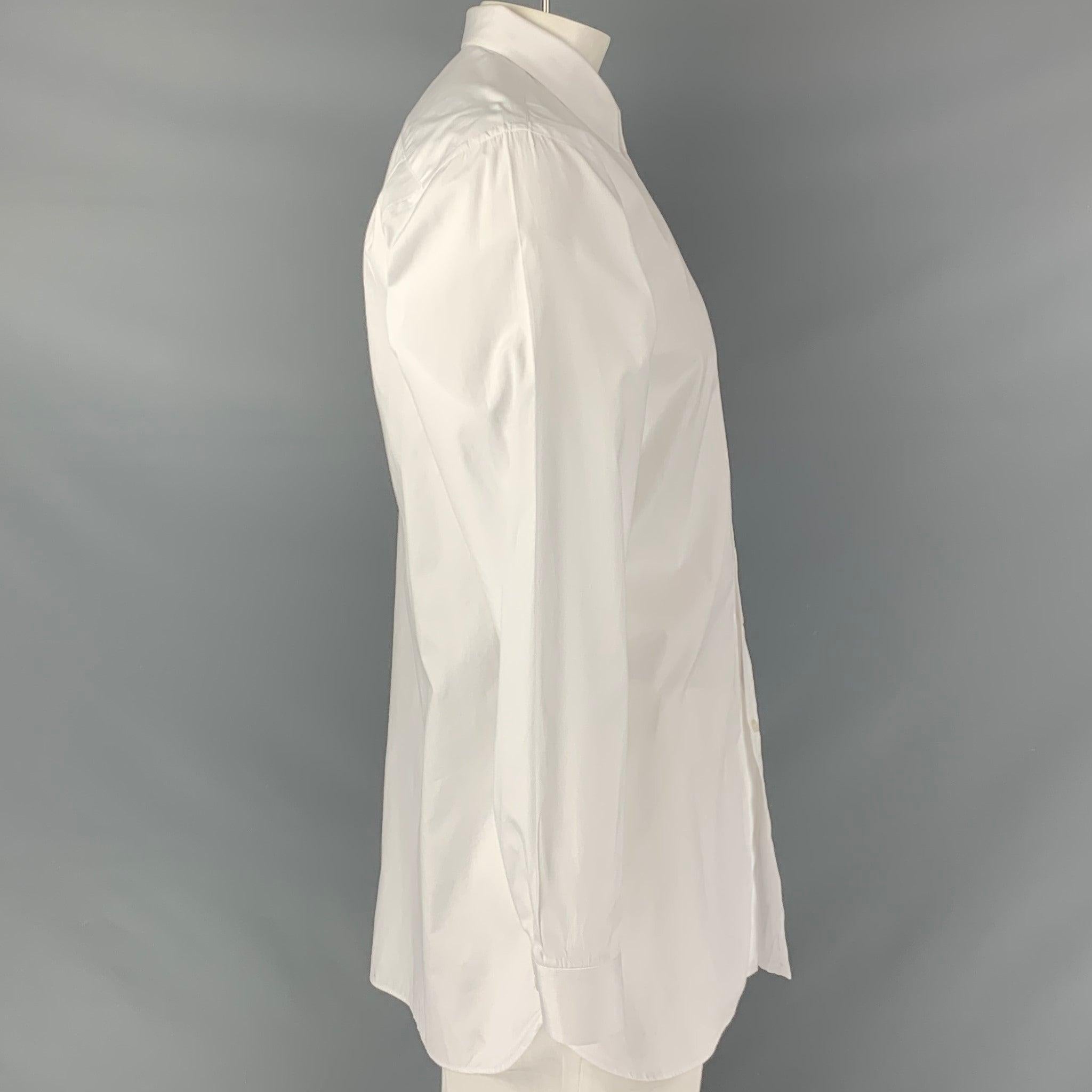 BURBERRY LONDON long sleeve shirt comes in a white cotton fabric featuring a straight collar, and a button down closure. Very Good Pre-Owned Condition. Minor signs of wear. 

Marked:   44- 17 1/2 

Measurements: 
 
Shoulder: 19 inches Chest: 46