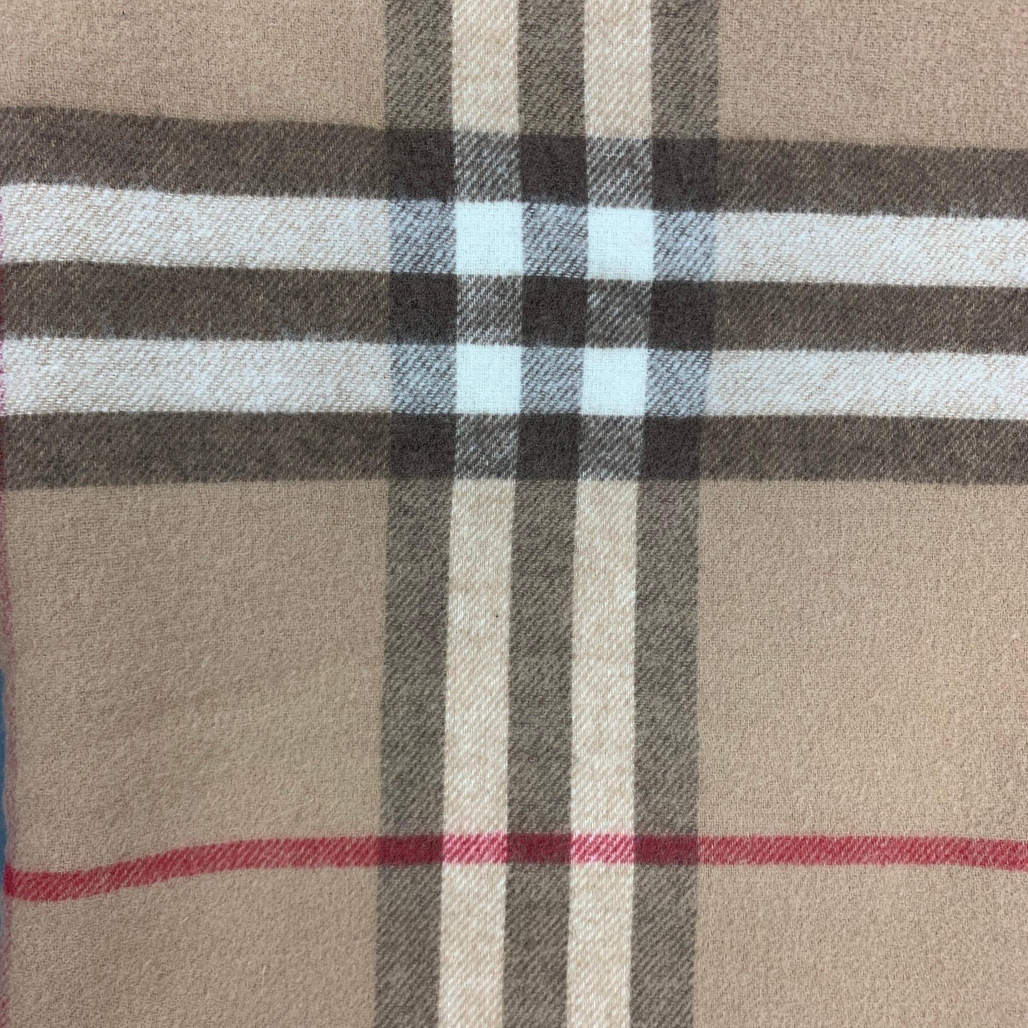 BURBERRY LONDON scarf comes in a tan & brown plaid merino wool / cashmere featuring a reversible style, patch pockets, and three inch trim. 

Very Good Pre-Owned Condition.

Measurements:

31 in. x 84 in. 