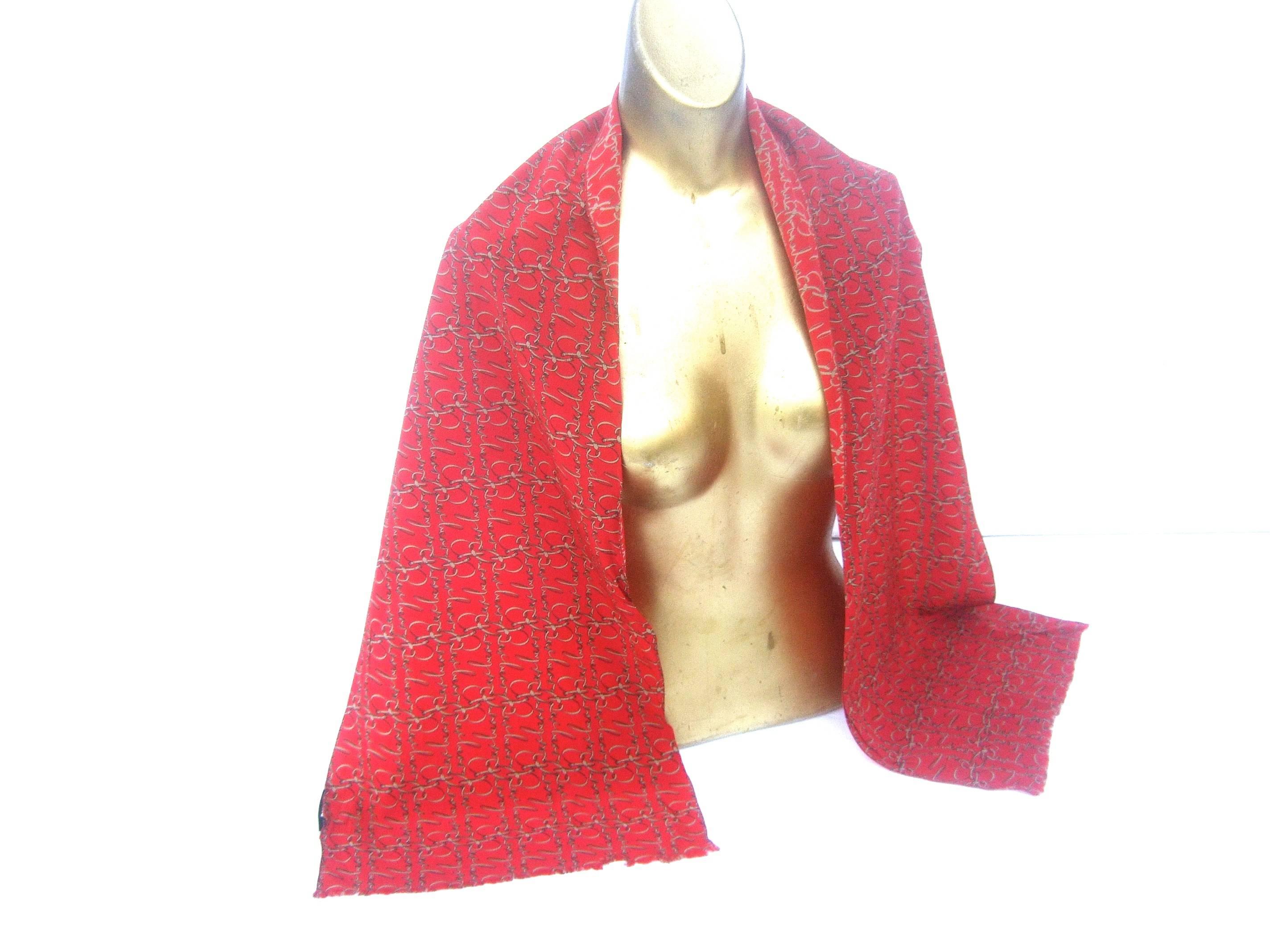 Burberry luxurious red silk oblong scarf c 21st C
The stylish oblong scarf is illustrated with Burberry's
script name repeated throughout 

The script B initial in their name is designed 
in the style of a golden bridal buckle 

Makes an elegant