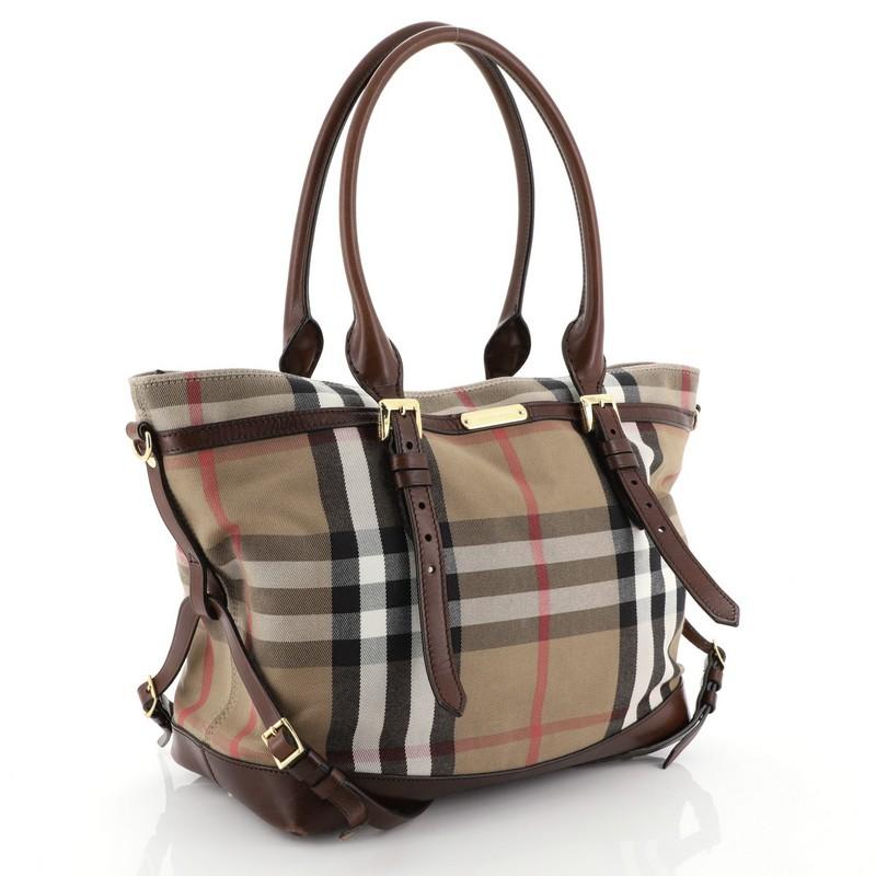 This Burberry Marta Convertible Diaper Bag House Check Canvas Large, crafted from signature burberry house check canvas, features dual-rolled should strap with belted accents, removable adjustable shoulder strap, large exterior snap pockets at front