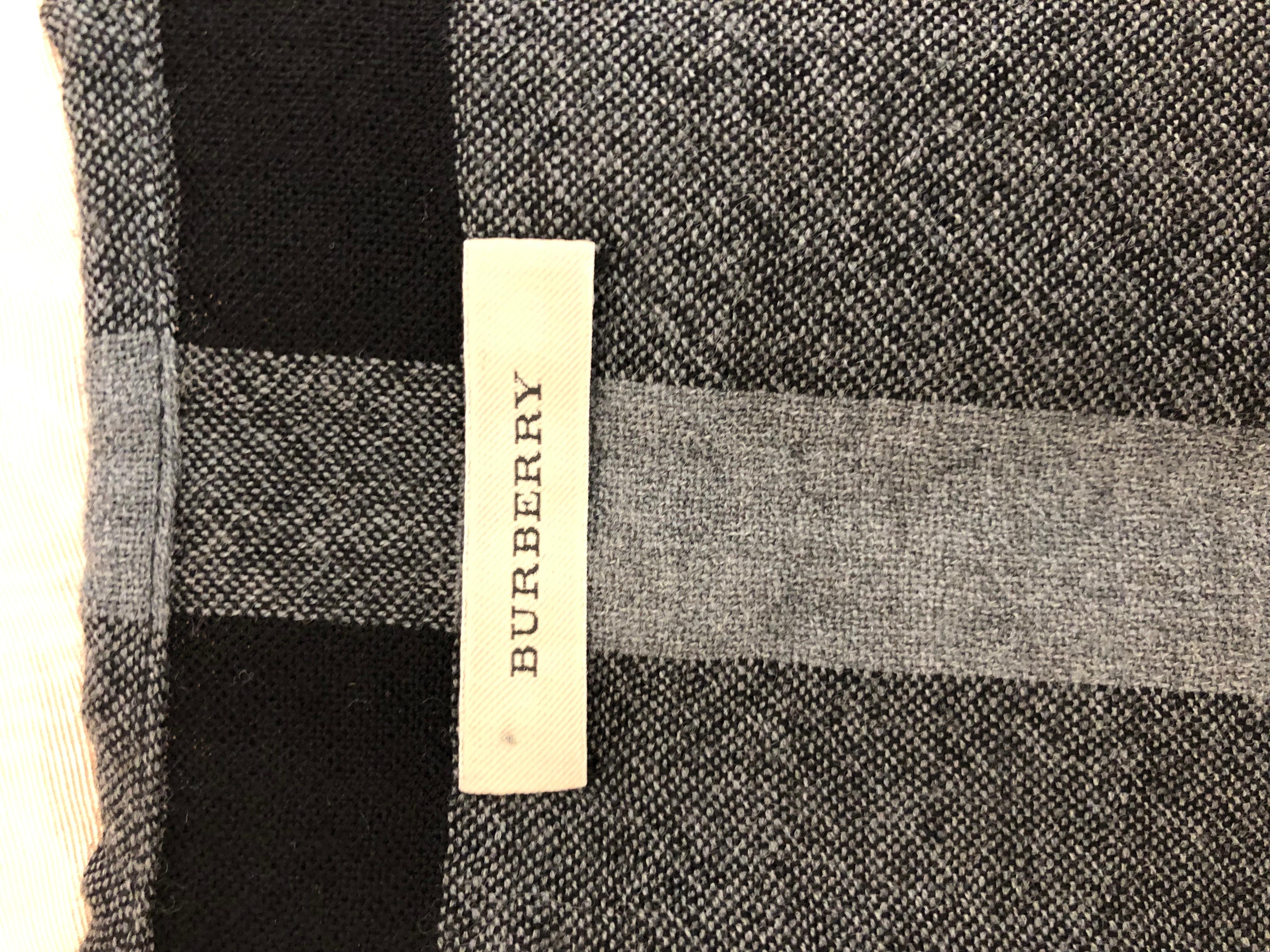 This Burberry fine wool merino grey and black shawl/cape with a fringe trim, is in excellent condition. Made in Scotland.