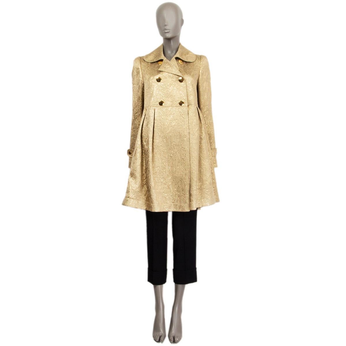 100% authentic Burberry double breasted flared brocade coat in gold wool (39%), silk (39%) and polyester (22%) with epaulettes at sleeve-cuffs. Closes with three gold-tone buttons at the front, has pleats under the waist-line and slit pockets. Lined
