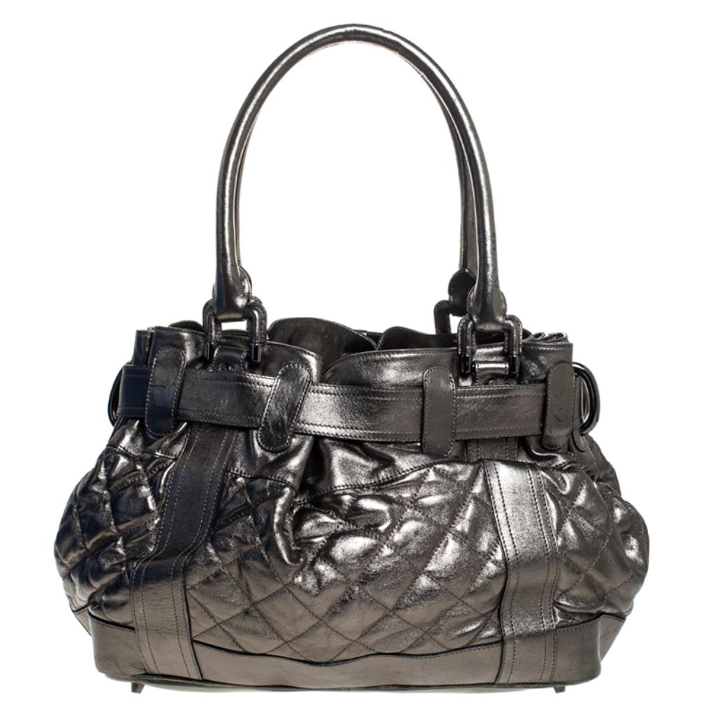 Complete a stylish look with this beautiful Beaton tote from Burberry. The leather exterior has been adorned with a quilted pattern and belt detailing, giving the piece a unique touch. It features dual handles and has a nylon lined interior that