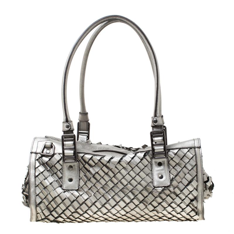 Simple and in style, this satchel from Burberry definitely needs to be in your closet. The bag, crafted from metallic grey leather in a woven style, spells creative excellence. It features two top handles and two compartments for your daily