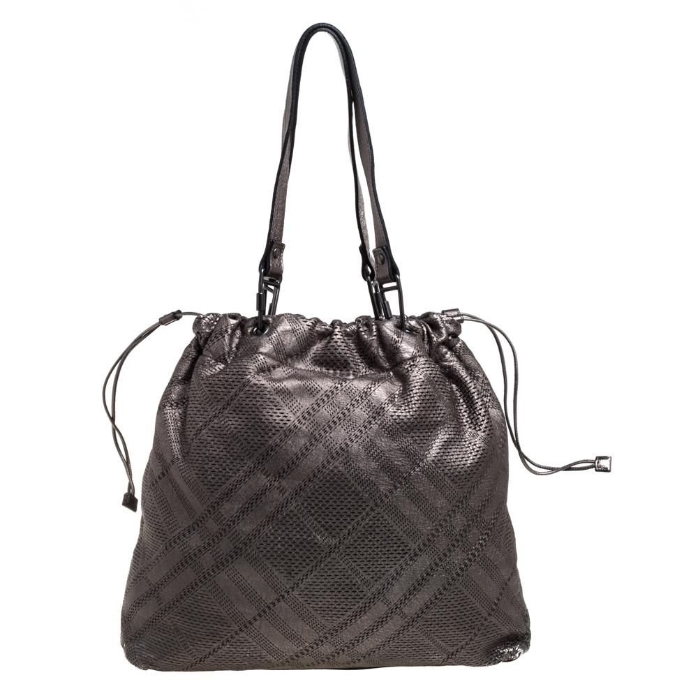 Stunning like no other, this tote by Burberry is sure to make a stylish statement! The metallic creation is crafted from leather and features impressive lasercuts adorning the exterior. It has an open-top that reveals a fabric-lined interior with