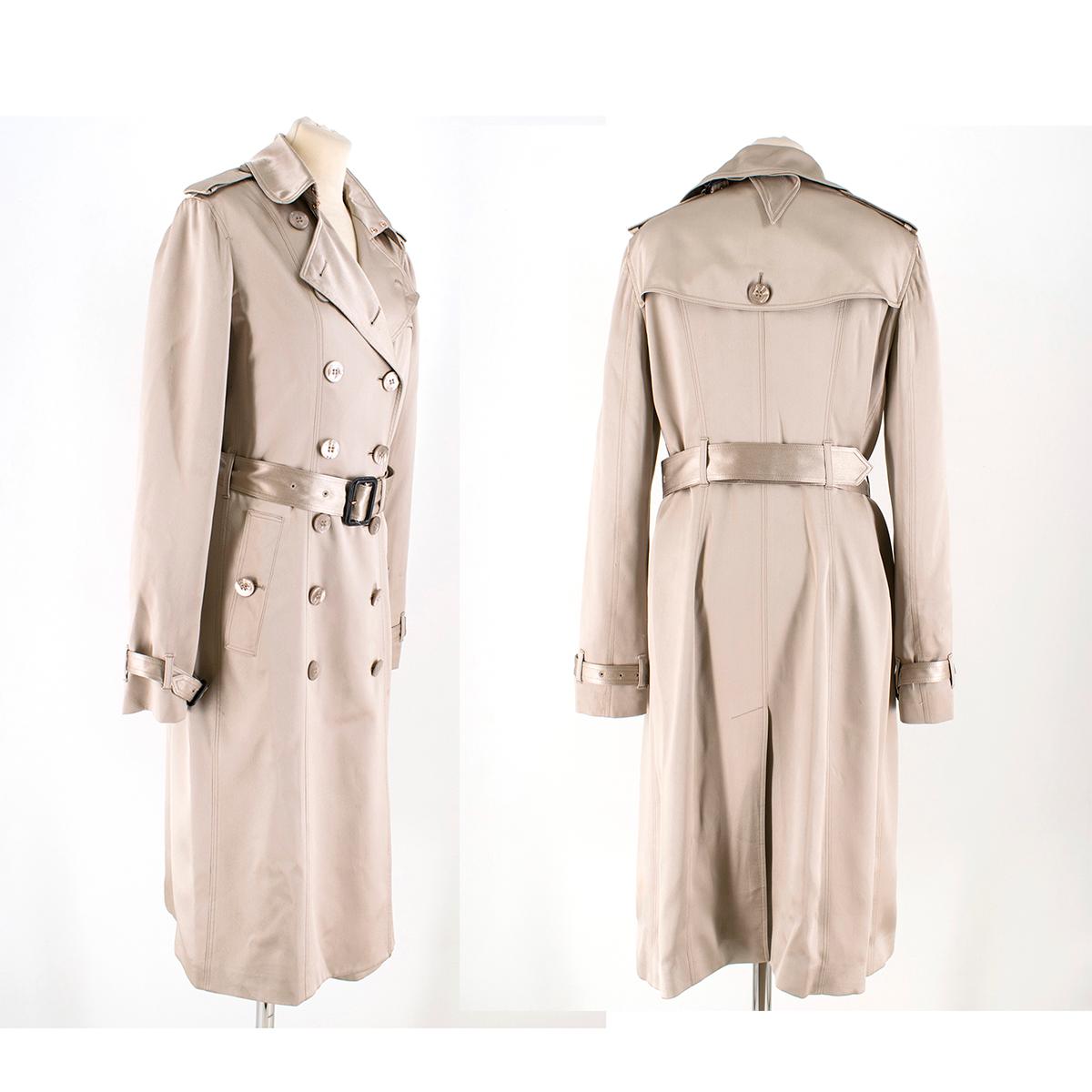Burberry Metallic Nude Silk Double-Breasted Wrap Trench Coat

- Metallic nude, silk trench coat
- Double-breasted buttoned fastening closu
- Adjustable buckle strap at cuffs
- Side buttoned pockets
- Adjustable waist belt with black leather buckle
-