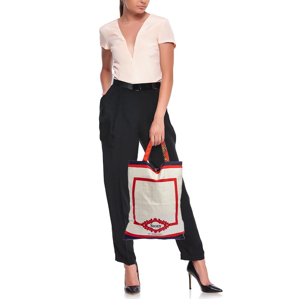 Add some magic to your everyday attire with this super stylish and classy silk tote. This bag is lined with silk that provides balance and shape. This beautifully-printed tote by Burberry is equipped with two top handles. Be it any occasion, this