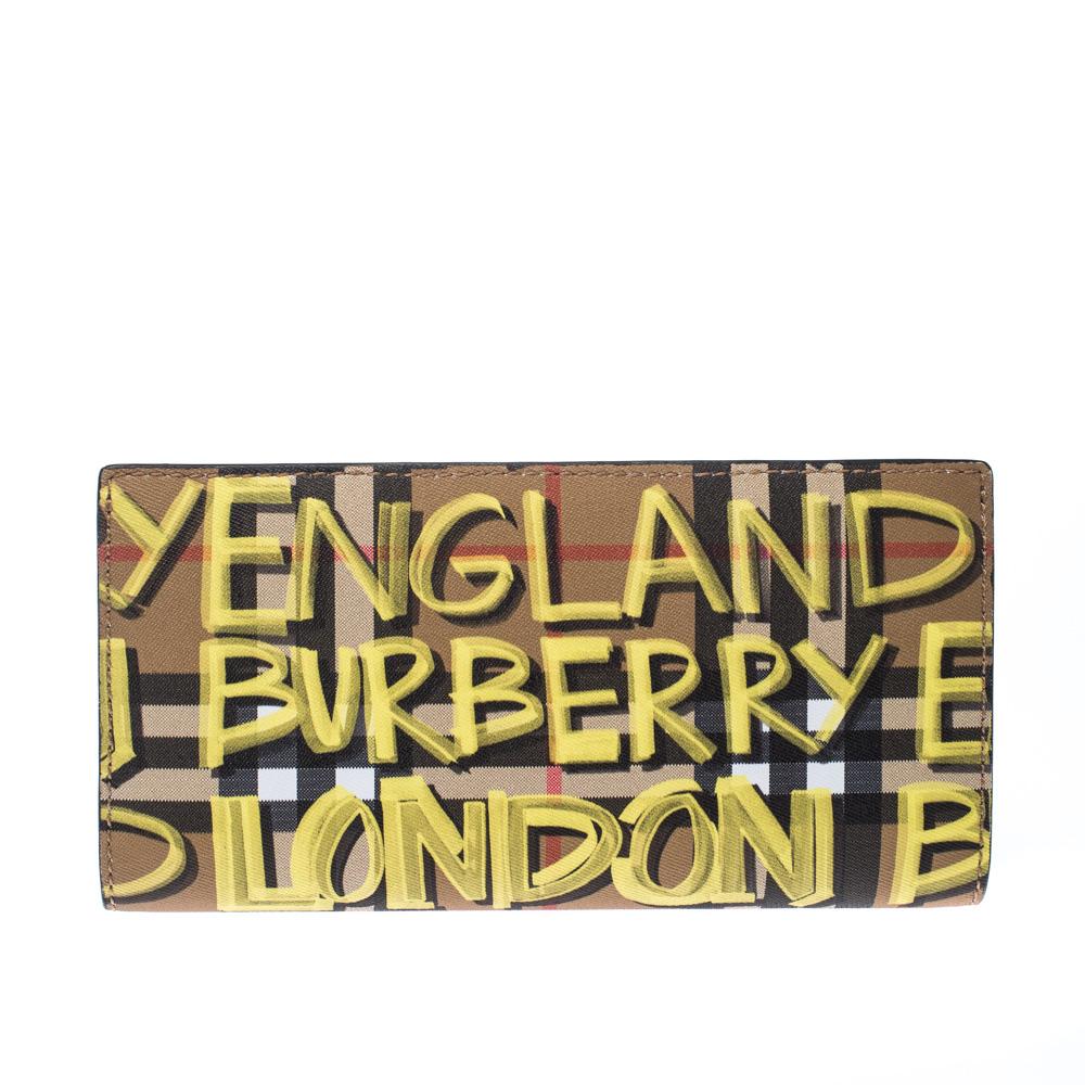 This wallet from Burberry brings along durability and functional style. It comes crafted from Check coated canvas and detailed with graffiti prints. It is equipped with multiple slots and compartments just so you can neatly carry your cards and