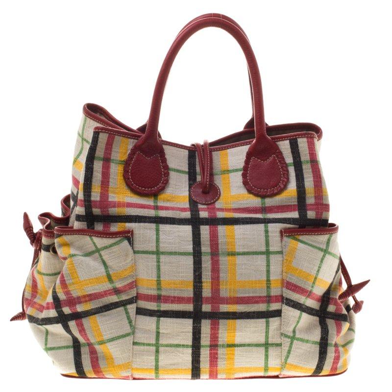 Fun and colorful! The House Check tote from Burberry is perfect to go along with your happy-go-lucky mood! The bag features dual rolled top handles, protective metal feet and an extra pouch to secure your essentials.The ruffled bow side-pockets