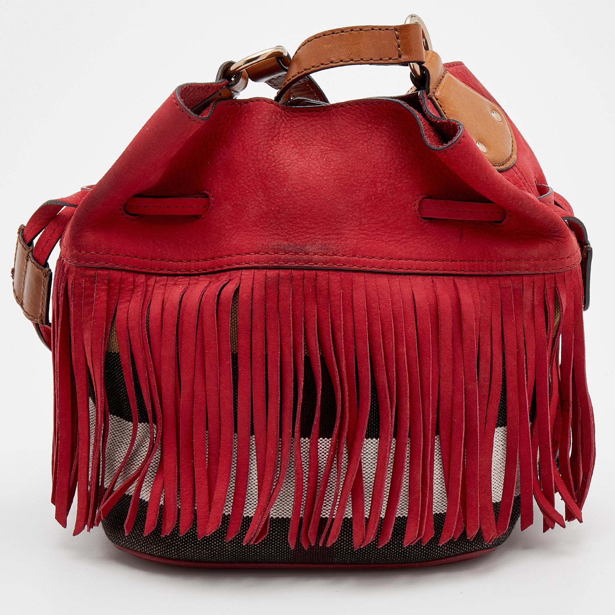 Ensure your day's essentials are in order and your outfit is complete with this Burberry bag. Crafted using leather, suede, and canvas, the bag has a shoulder strap, fringe details, and a lined interior.

