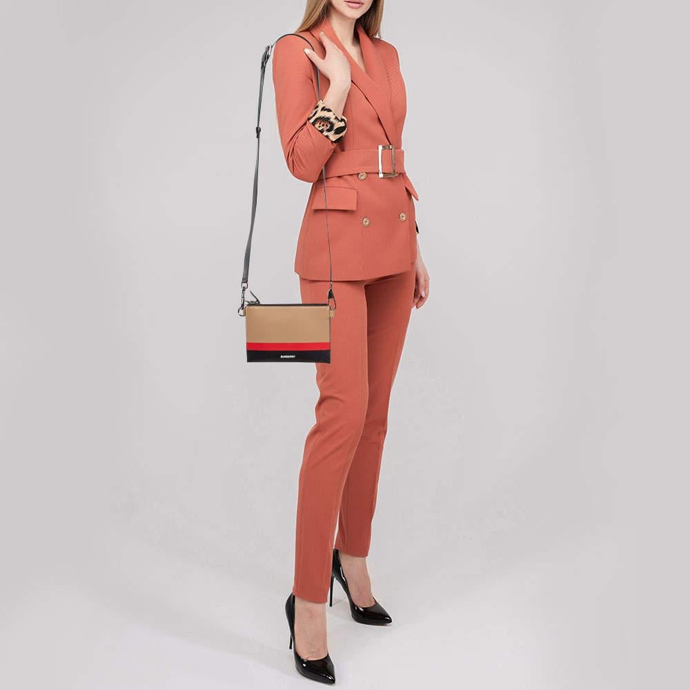 This lovely crossbody bag by Burberry will lend a stylish accent to your look of the day. It features a leather exterior fabric interior silver tone hardware and a shoulder strap.