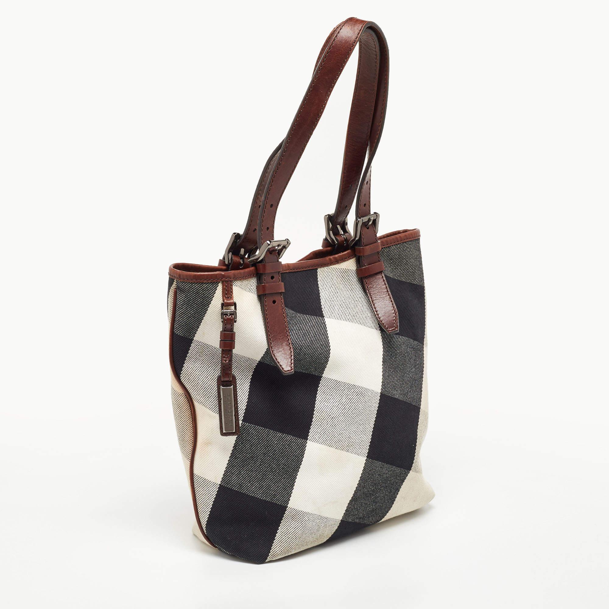 Bringing a mix of timeless fashion and fine craftsmanship is this tote. The bag comes with a durable exterior, comfortable handles, shiny hardware, and a capacious interior. Fine elements complete the tote in a luxe way.

