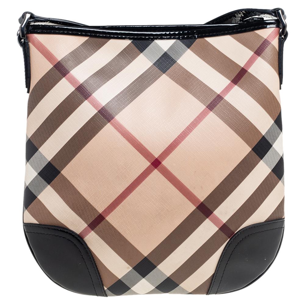 This stylish crossbody bag from Burberry has been crafted from PVC in signature nova check and accented with patent leather trims. The zip-top closure opens to a fabric-lined interior. The bag comes with a shoulder strap and is perfect for everyday