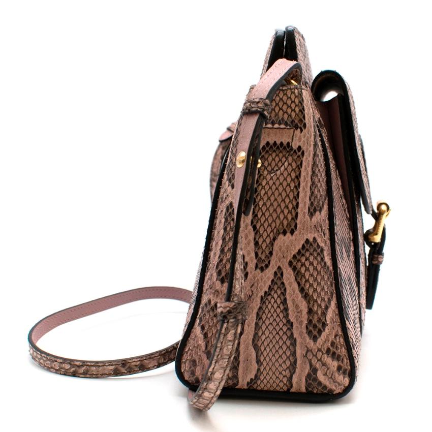 Burberry Cross Body Python Leather Handbag

- Cross Body Strap 
- Strap adjustable and removable 
- Front pocket with magnetic closure
- Interior zip pocket 
- Smooth Leather Lining 

Please note, these items are pre-owned and may show signs of