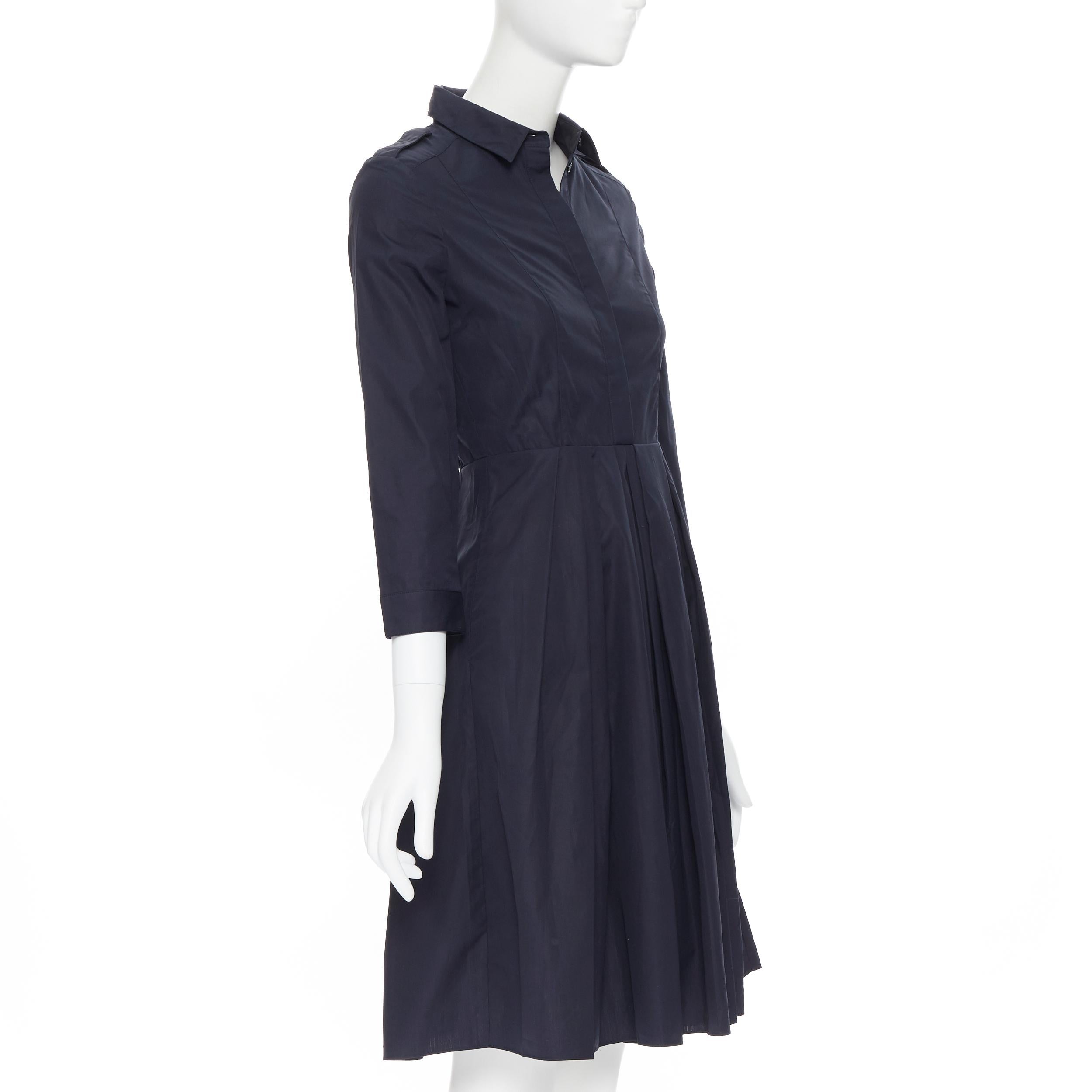 BURBERRY navy blue cotton pleated skirt safari detail flared dress UK4 XS 
Reference: SNKO/A00107 
Brand: Burberry 
Material: Cotton 
Color: Navy 
Pattern: Solid 
Closure: Button 
Extra Detail: Military inspired shoulder epaulette design. Concealed