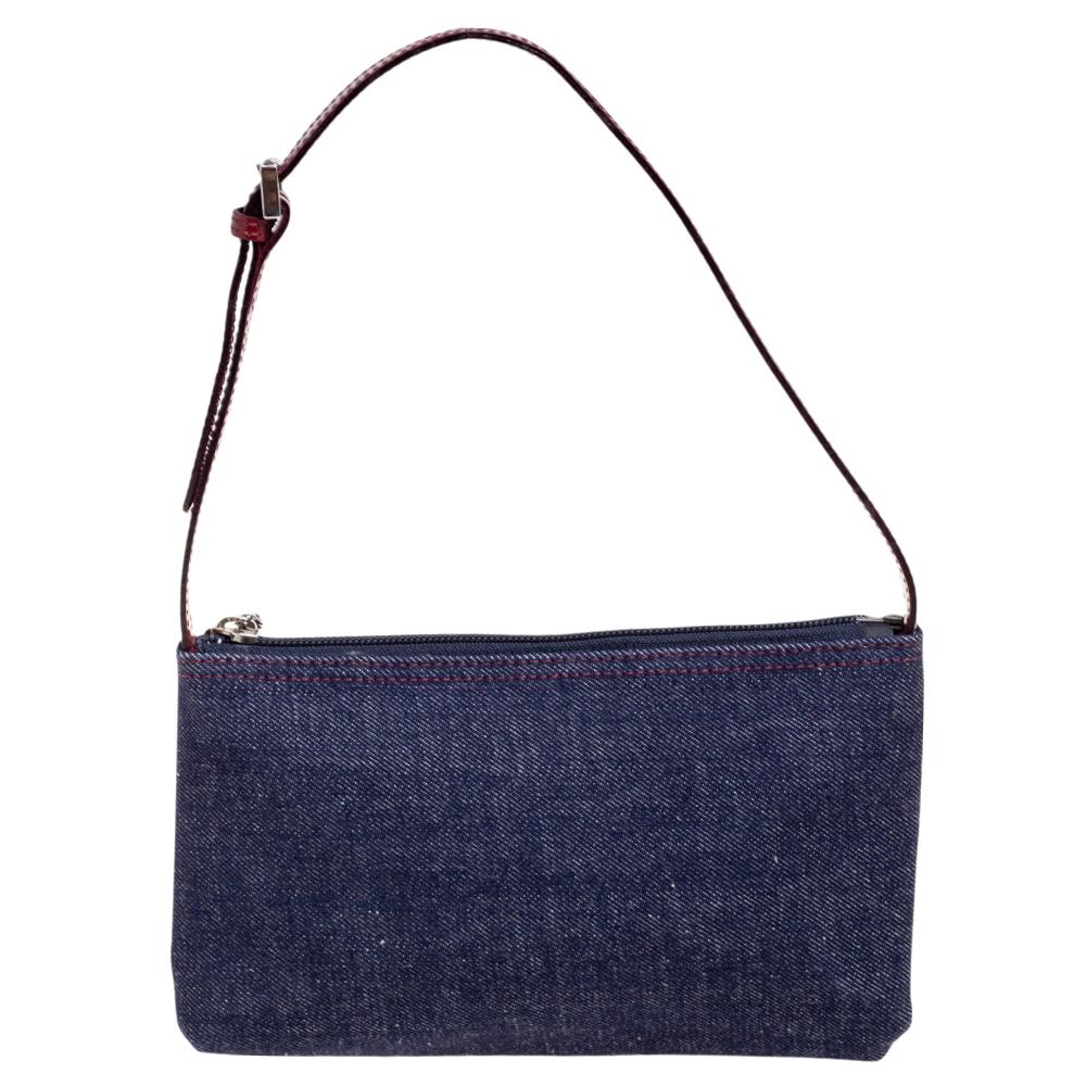 Burberry brings us this well-shaped baguette bag that has been crafted from denim. The canvas-lined interior is for your small belongings and the bag is complete with a shoulder handle and a check pocket at the front.

Includes: Original Dustbag