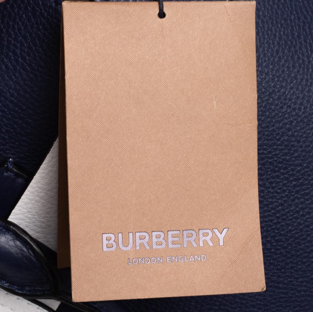 Burberry's Belt bag has an appealing design and a functional quality. Constructed using leather, the bag has two handles and a leather-lined interior. The belt detail that surrounds the top of the bag acts as the design's highlight.

Includes: