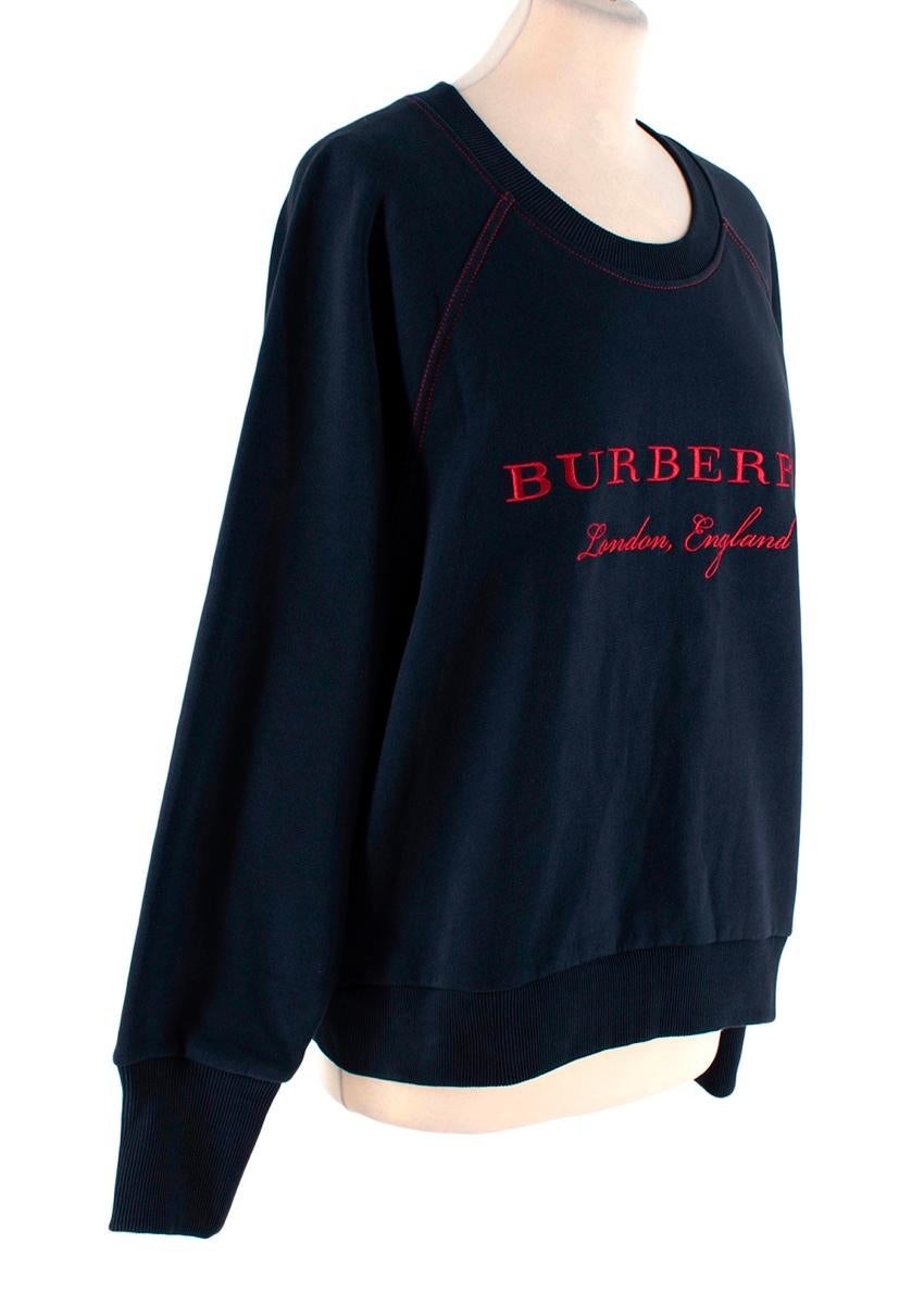 Burberry Navy Cotton Logo Embroidered Sweatshirt
 

 -Burberry dark navy crew neck sweatshirt 
 -Red Burberry London embroidery at the front 
 -Red tonal stitching
 

 Materials 
 80% Cotton
 20% Polyester 
 

 Made in Portugal 
 Wash & Dry Inside