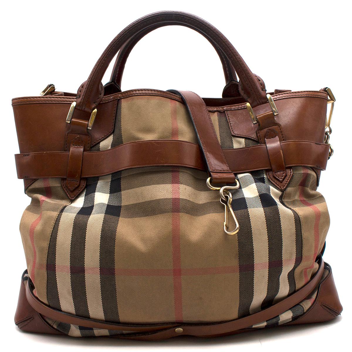 Burberry Nova Check Canvas & Leather Large Tote Bag

-Brown and tan plaid
-Leather and canvas
-Decorative buckle detailing 
-Top handles
-Removable shoulder strap
-Gold hardware 
-Two main open compartments
-One center zip compartment 
-Small zip