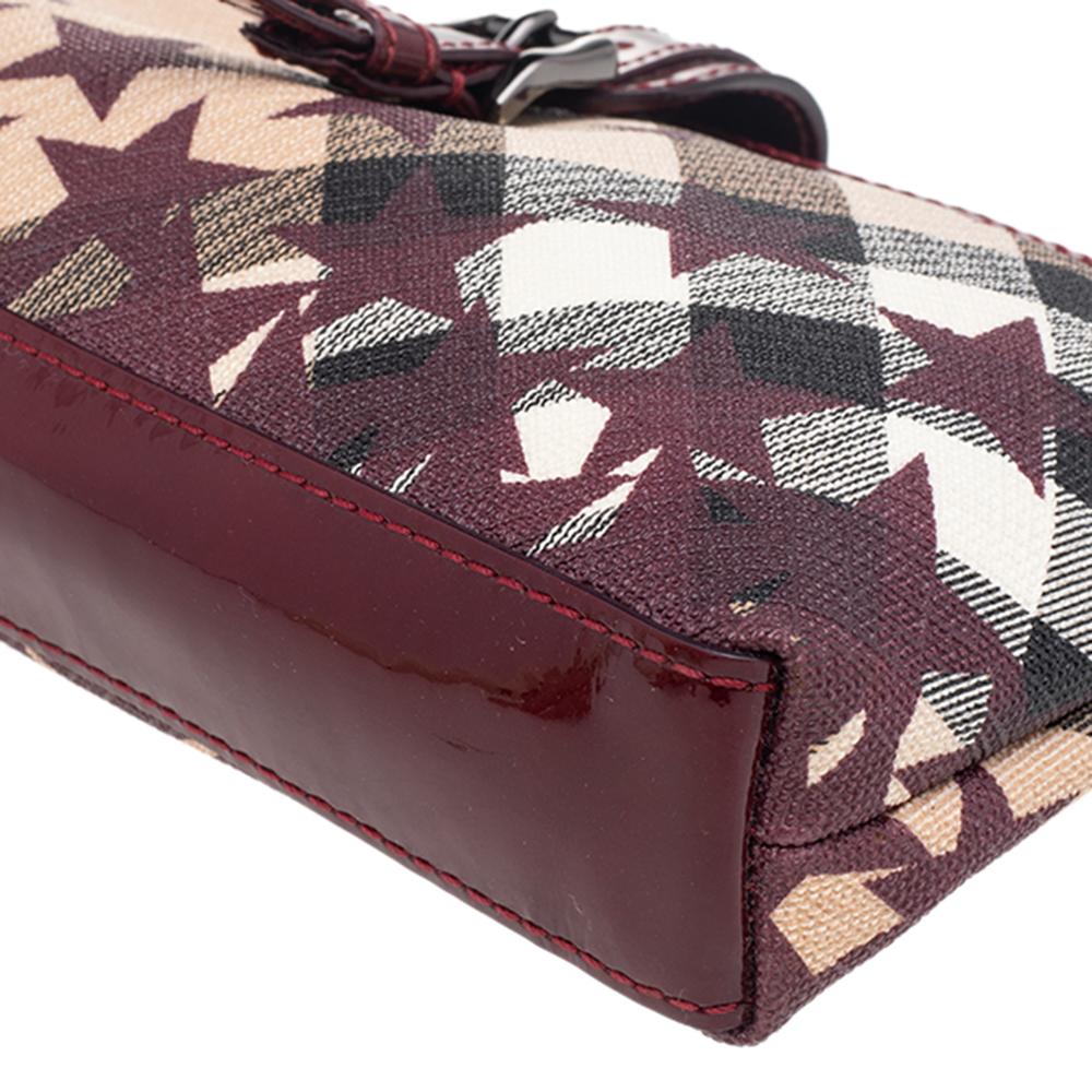 Perfect for casual outings, this accessory is sophisticated and elegant in its demeanor. Made from Nova check coated canvas, this Burberry clutch features patent leather trims and star motifs, a top zip closure, and a side wristlet. The spacious