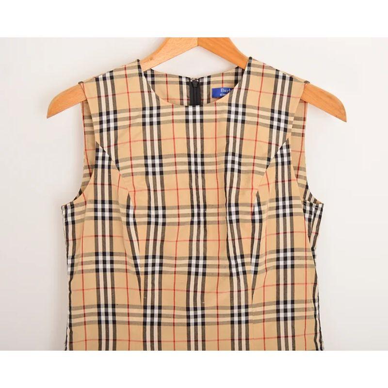 Iconic 2000's Burberry Nova check mini shift dress from the Burberry Blue Label for the Japanese Market. 

Features:
Classic shift style shape
Conceal zip up back
Rounded kneck
Above knee length hem
Sizing: Pit to Pit: 17.5''; Nape to Hem: