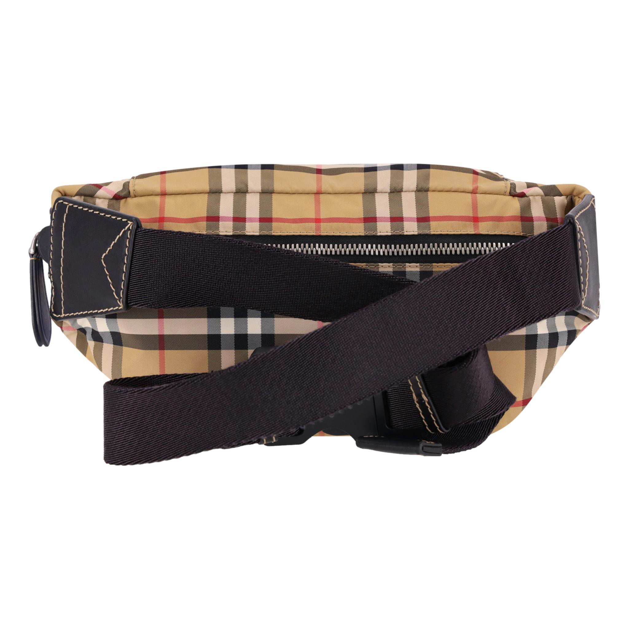 Burberry Nylon Vintage Check Belt Bag

Beige belt bag crafted from nylon and designed in Burberry's iconic Vintage Check pattern.

Featuring zipped front trimmed with black leather and adjustable canvas belt strap.

Rrp Approx. £650

Size – Height