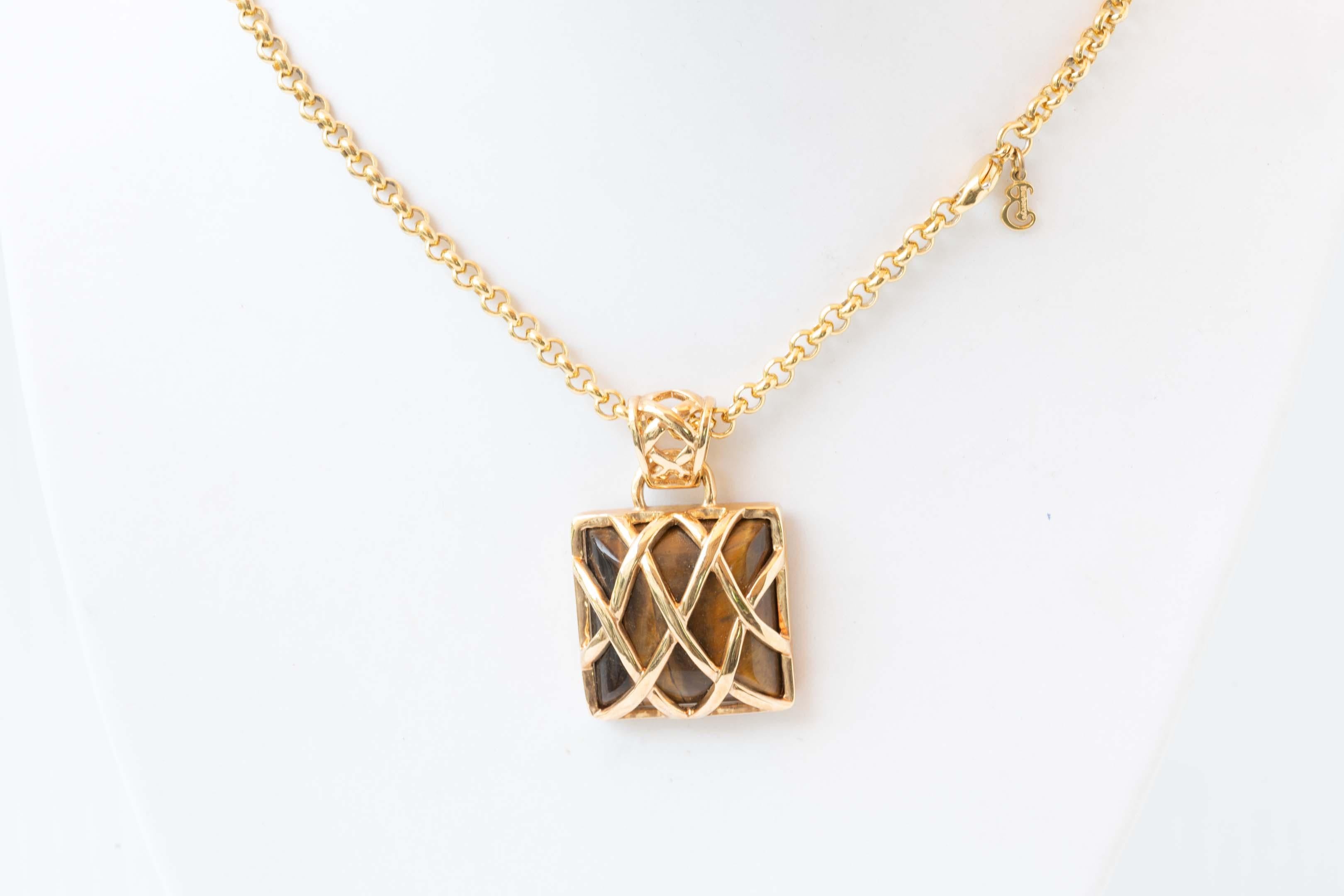 Burberry of London gold plated chain pendant with tiger eye gemstone and Burberry symbol chain. Measures 19 inches long and the pendant measures 1.2 inches long. Preowned, in excellent condition no box.