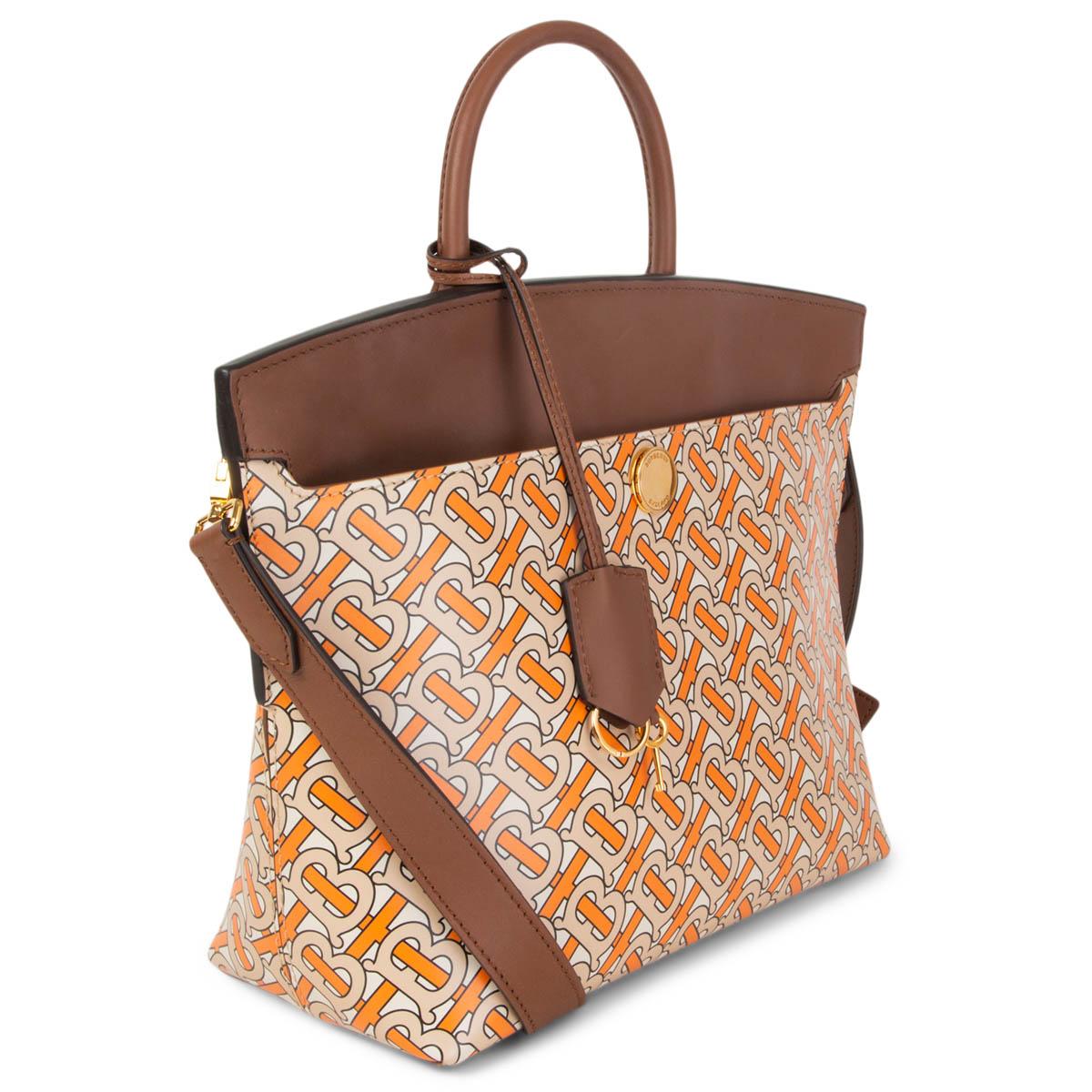 100% authentic Burberry Society top handle shoulder bag in pale beige, orange and black printed calfskin with brown flap, handles and shoulder strap. Lined in brown suede with one open pocket against the back. Comes with a detachable shoulder strap,