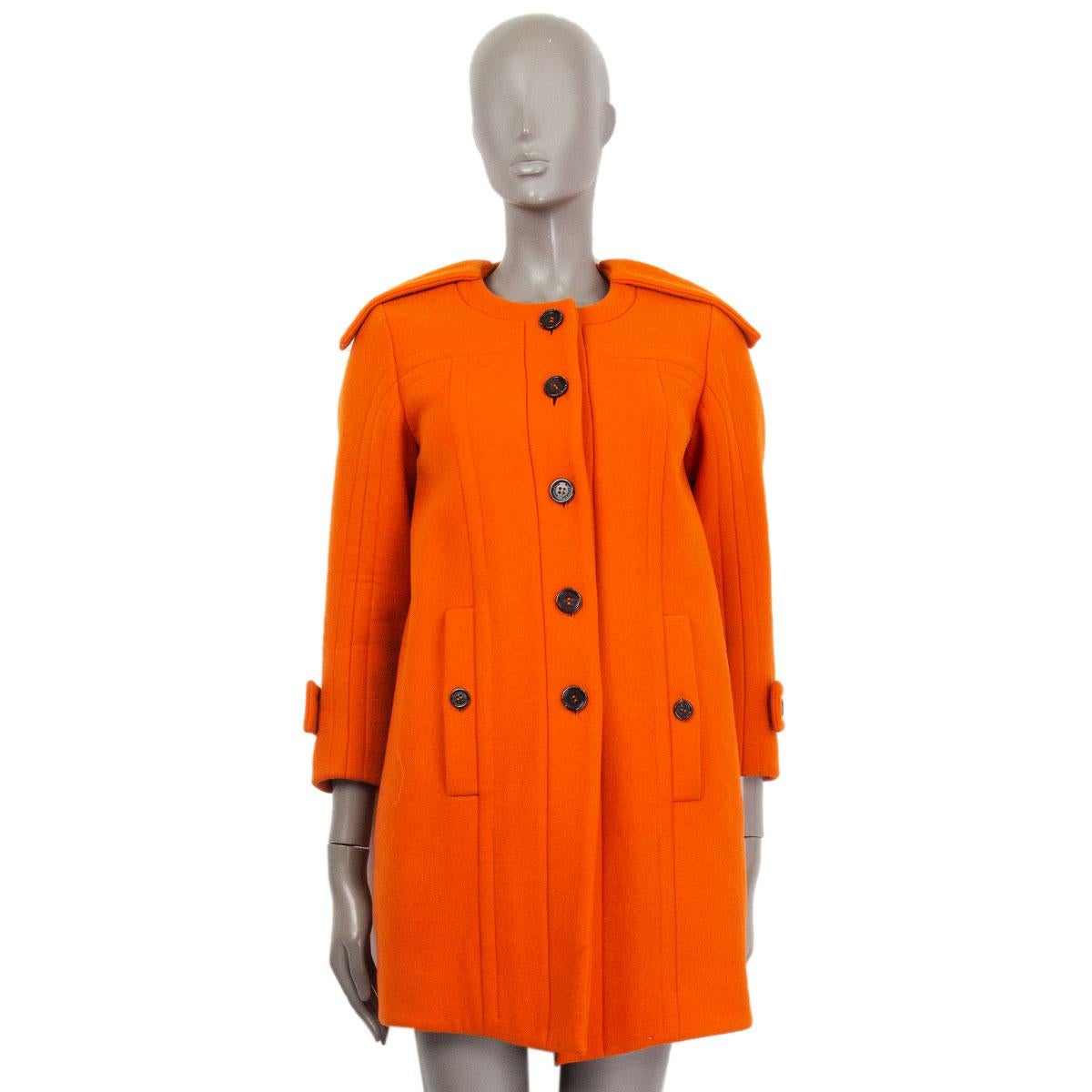 authentic Burberry Prorsum single breasted coat in orange wool (100%) with a flat collar, epaulettes on the shoulders and on the sleeves hems and embellished stitching. Closes with buttons on the front. Lined in acetate (52%) and rayon (48%). Has