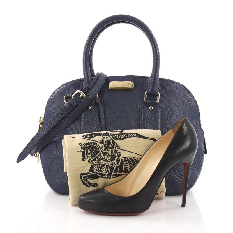 This Burberry Orchard Bag Check Embossed Leather Small, crafted from navy embossed leather, features dual rolled handles, Burberry logo metal plate and gold-tone hardware. Its two-way zip closure opens to a navy fabric interior with zip and slip