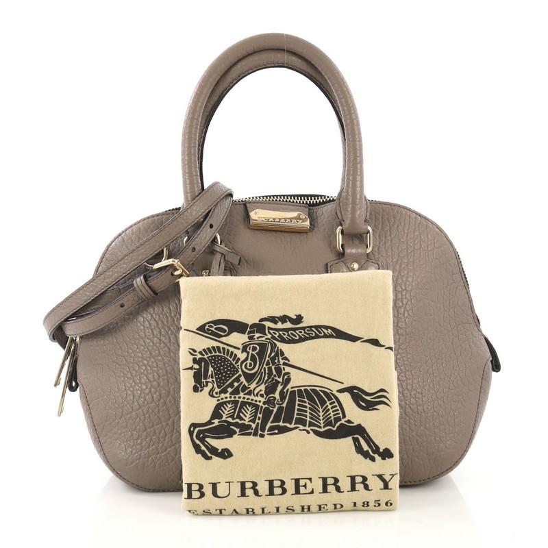 This Burberry Orchard Bag Heritage Grained Leather Small, crafted from gray grained leather, features dual rolled handles and gold-tone hardware. Its two-way zip closure opens to a black fabric interior with zip and slip pockets.

Estimated Retail