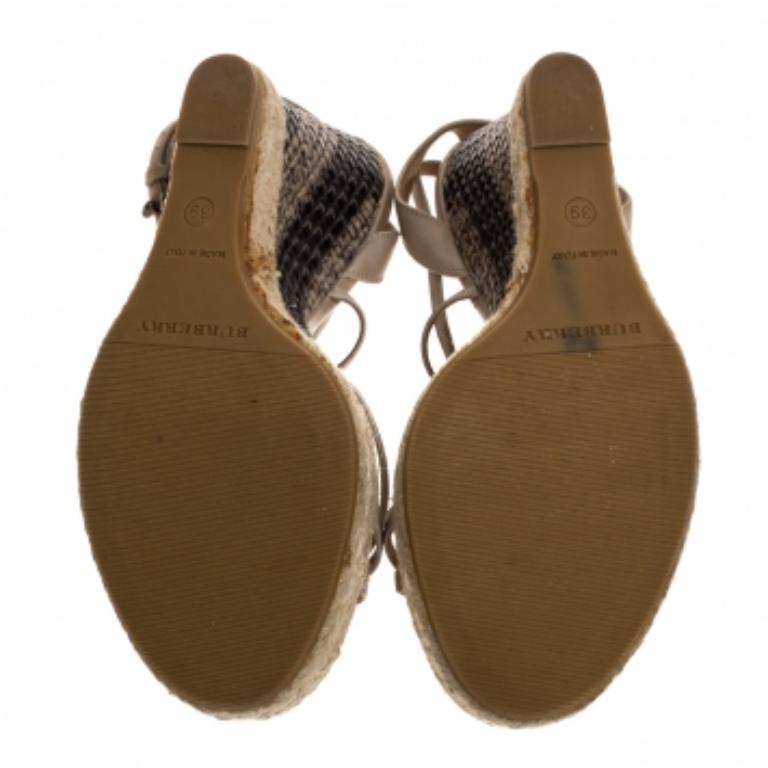 The house of Burberry brings you these impressive sandals that complement any outfit. Keep your comfort at a maximum with these beautiful leather sandals. They feature a strappy design at the vamps and ankles, woven espadrille wedges, and buckle
