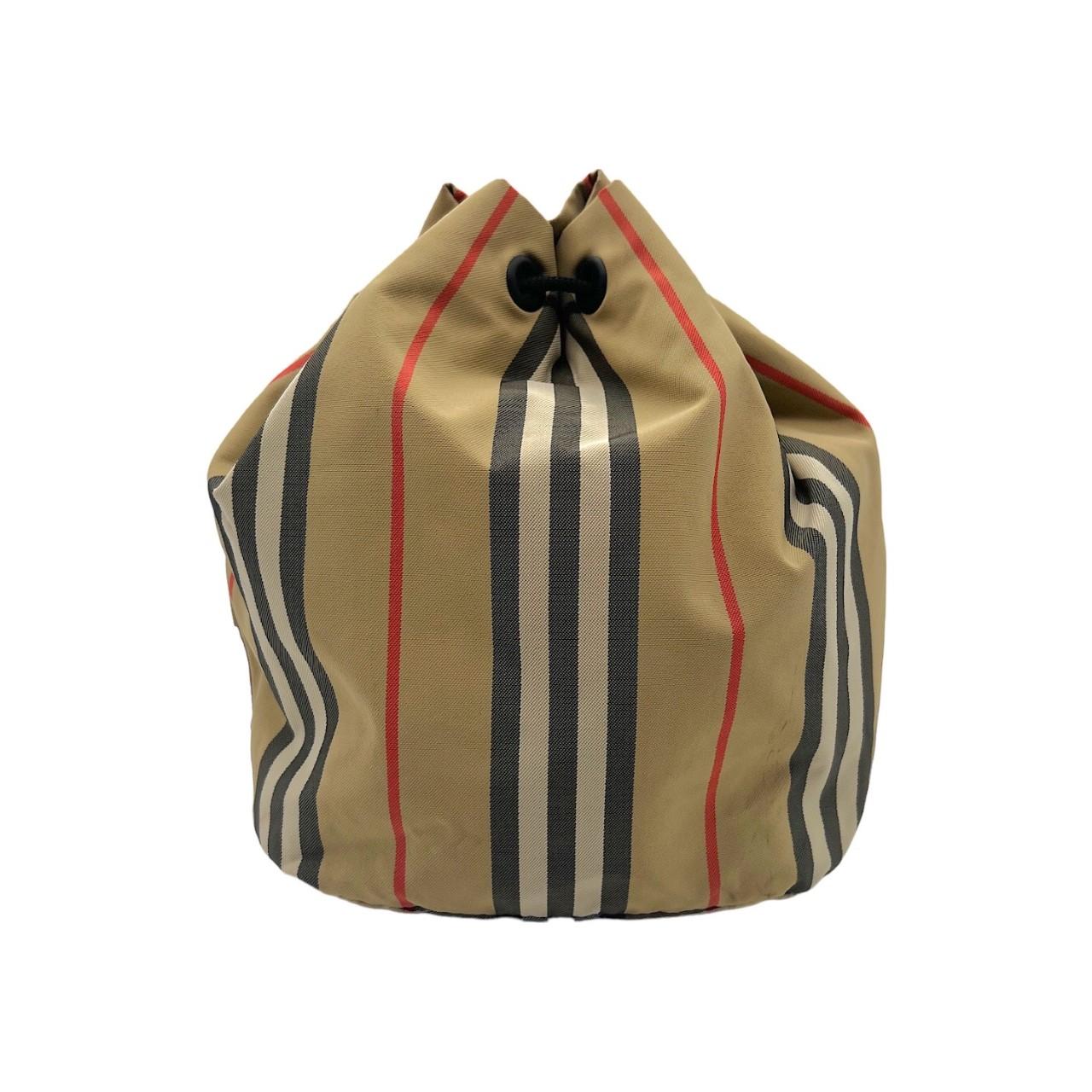 Burberry Phoebe Heritage Stripe Bucket Bag. Made in Moldova, this drawstring bag is finely crafted of a nylon exterior with Burberry's iconic Heritage Stripe pattern and matte black hardware. It features the classic Burberry logo lettering and it