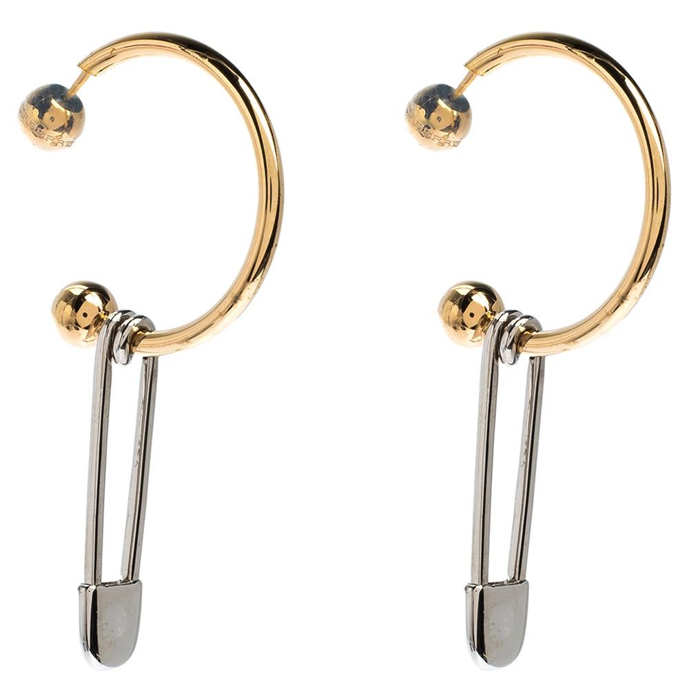 These Burberry earrings are a beauty. The design consist of safety pins formally referred to as an 'archival kilt pin' dangling from hoops. Sculpted from gold-tone and silver-tone metal, the pair has a smooth finish and can be worn on multiple